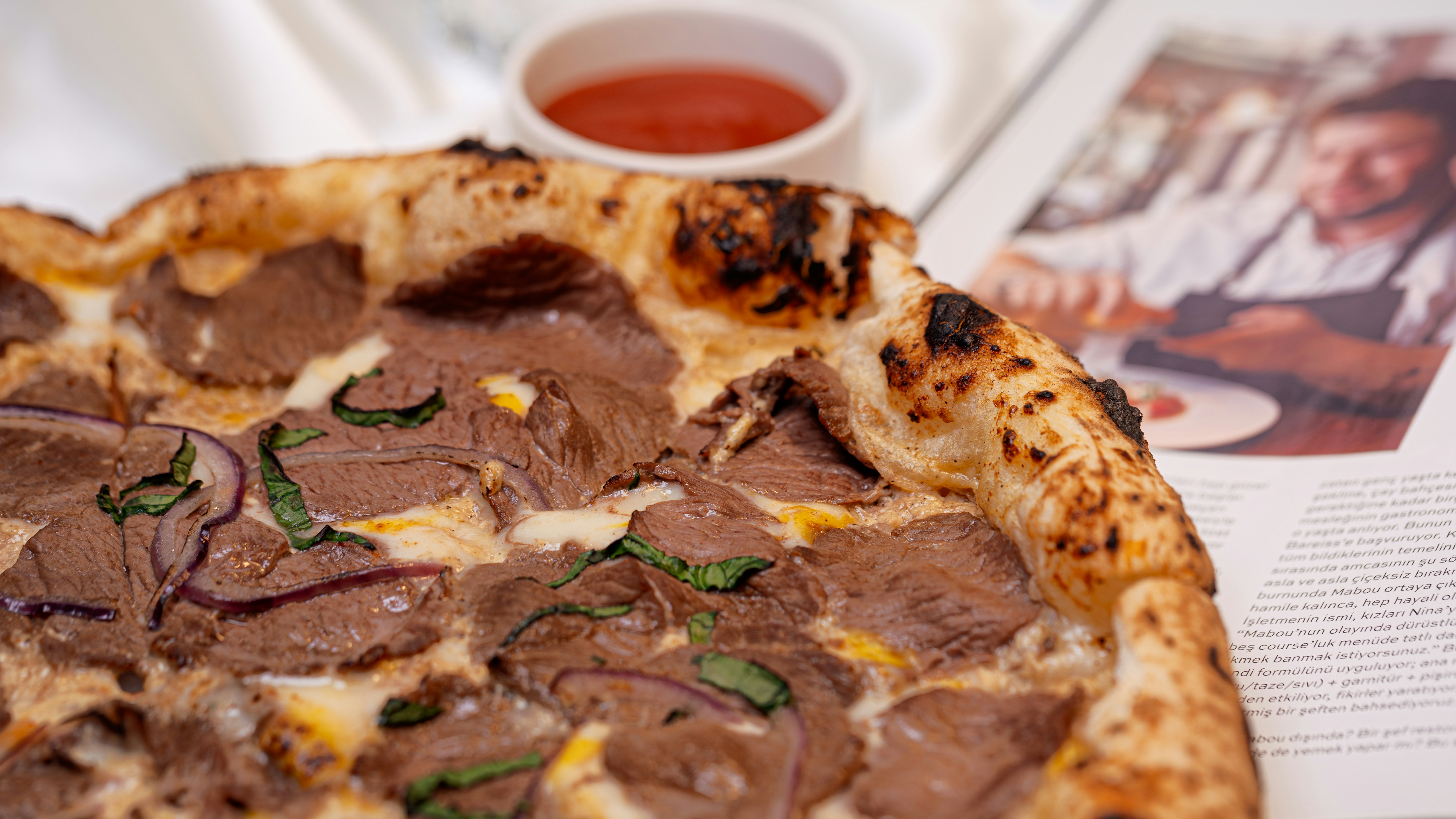 Close-up of a delicious pizza with meat and onions.