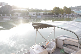 Pontoon boat on a calm river at sunrise.