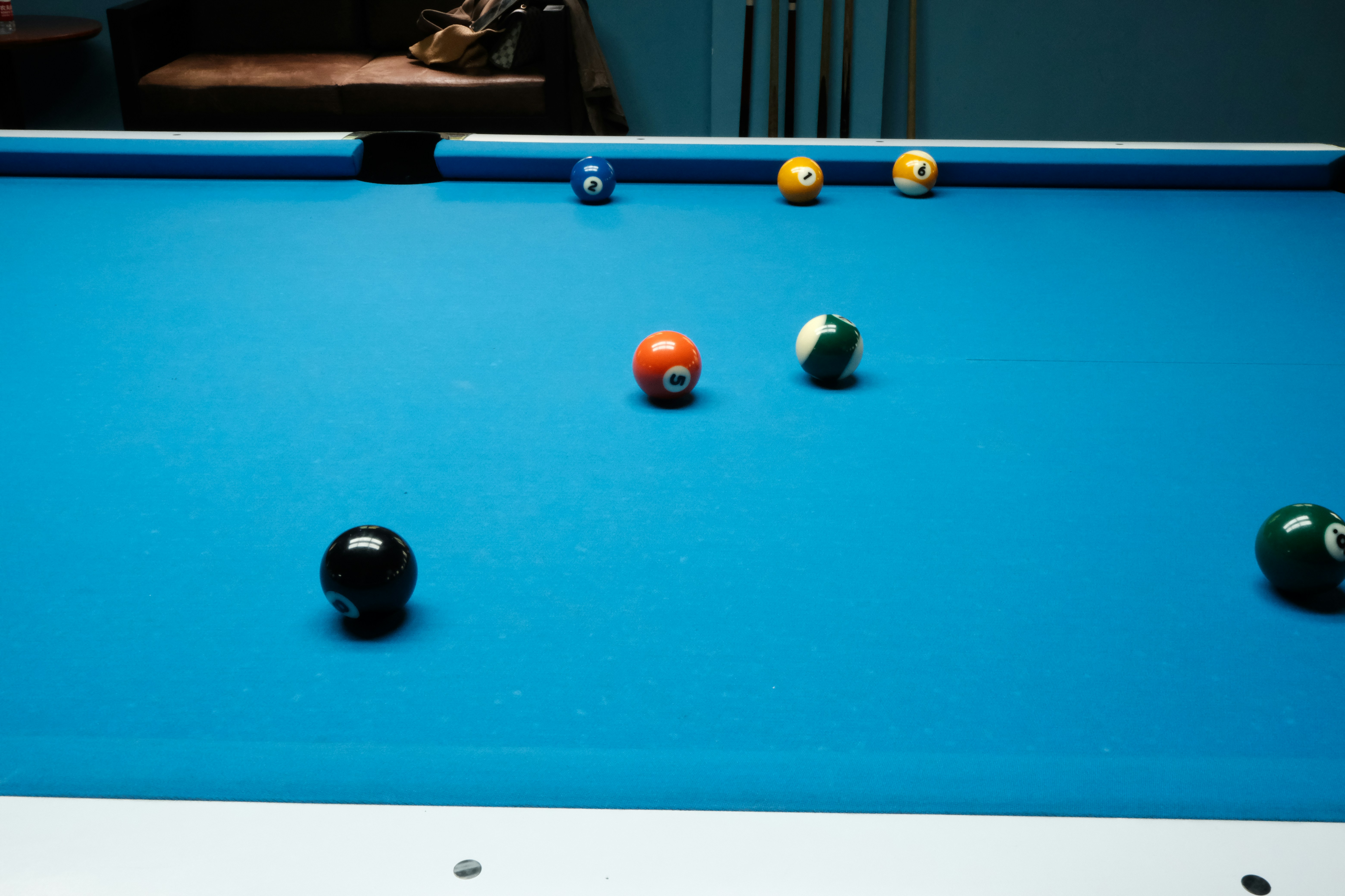 Pool table with several colored balls scattered