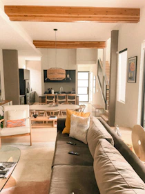 Modern living room with open kitchen and wooden beams