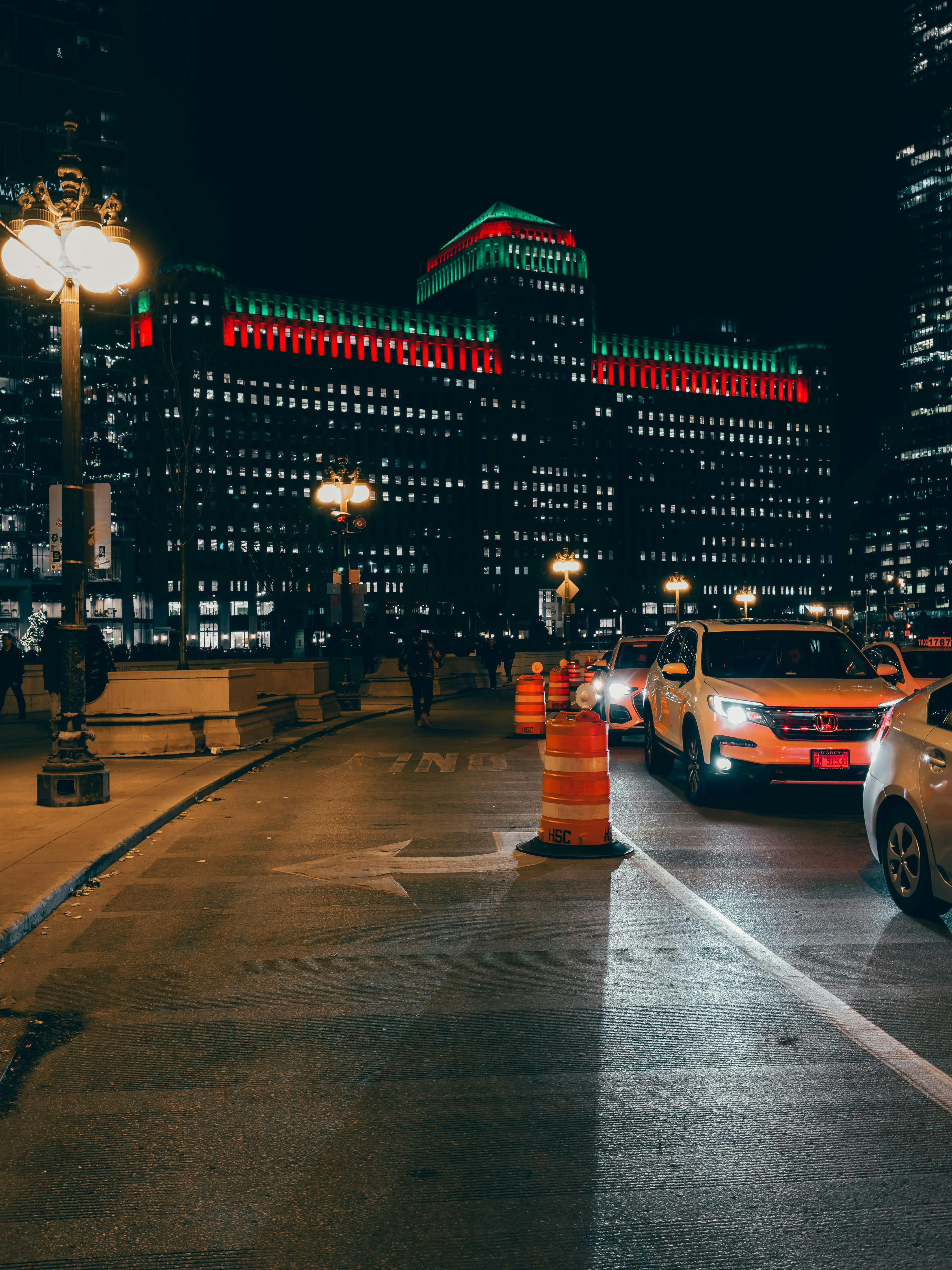 City street at night with cars and illuminated buildings. photo – Free ...