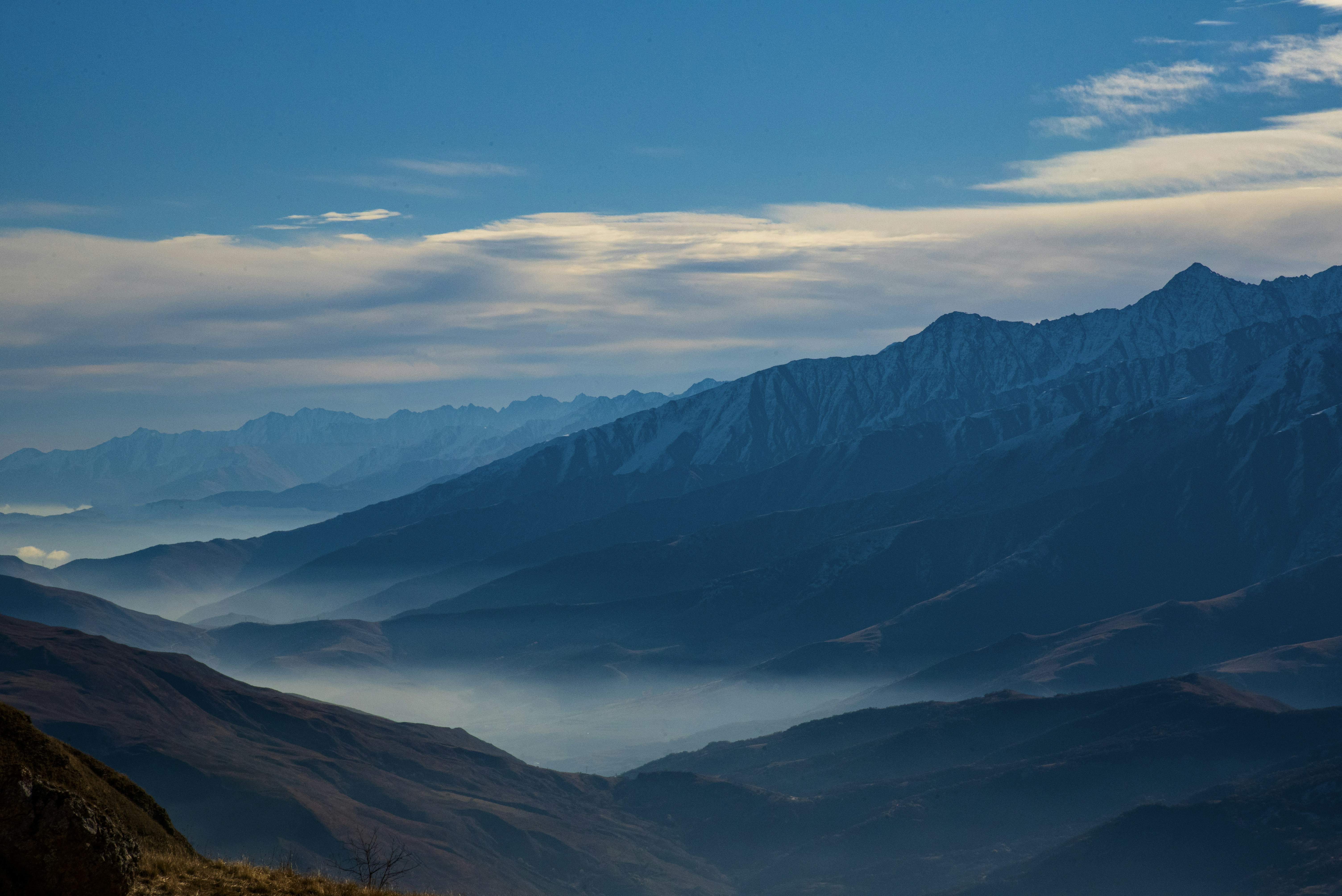 Misty blue mountains under a clear sky