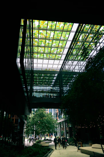 Modern building with a green glass ceiling and trees