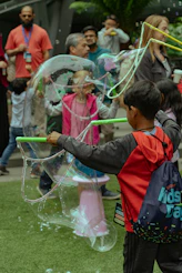 Children playing with large soap bubbles outdoors