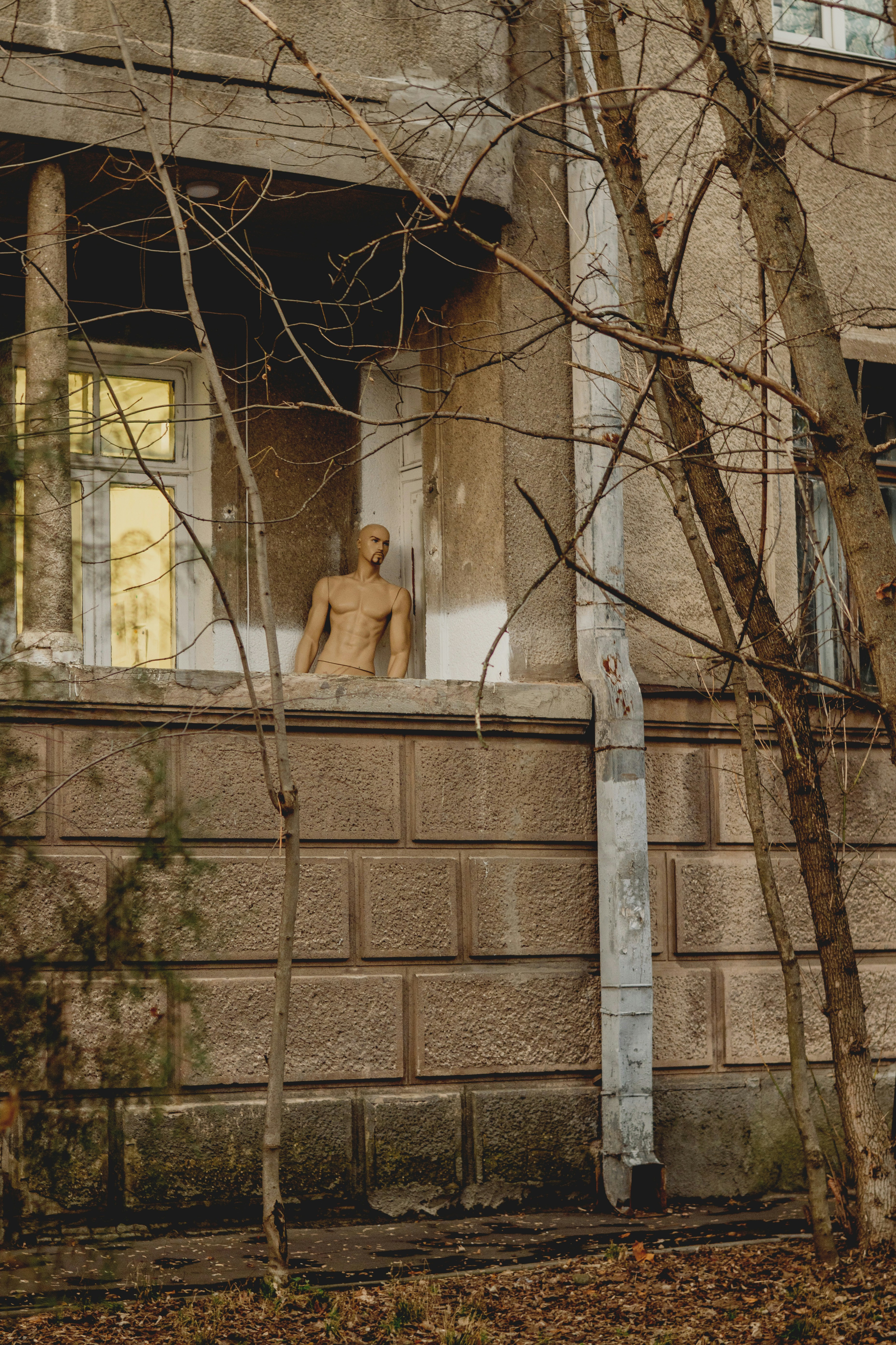Mannequin in an abandoned building window