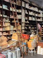 A cluttered hardware store with shelves full of boxes
