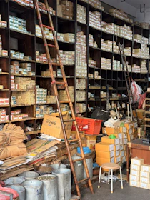 A cluttered hardware store with shelves full of boxes