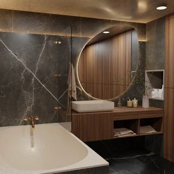 Modern bathroom with marble, wood, and round mirror.