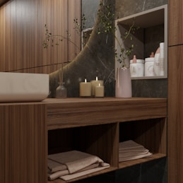 Modern bathroom vanity with candles and toiletries.