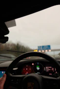 Driving a car on a highway with dashboard visible dashboard.