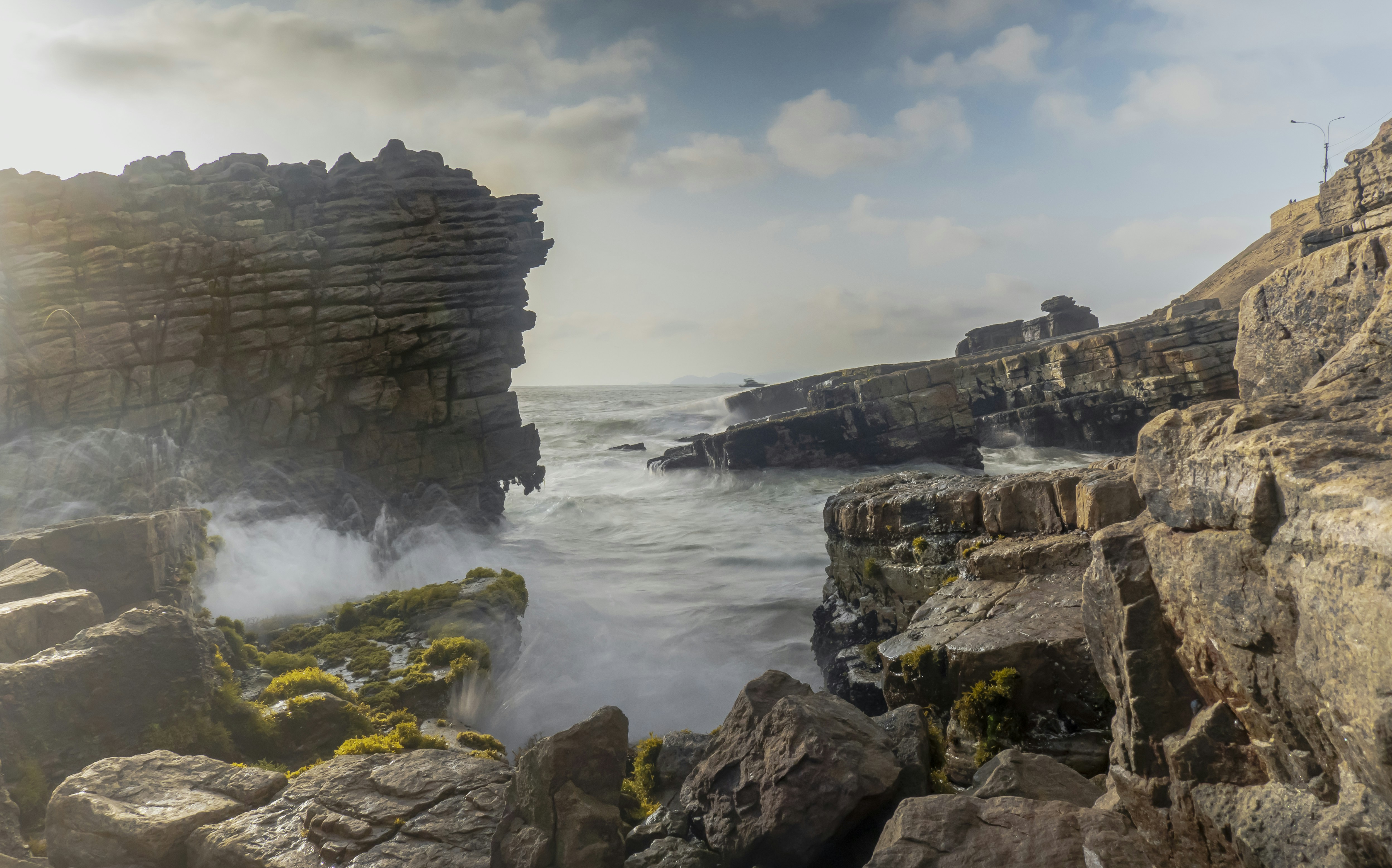 Waves crashing along the coastal cliffs in Lima, Peru