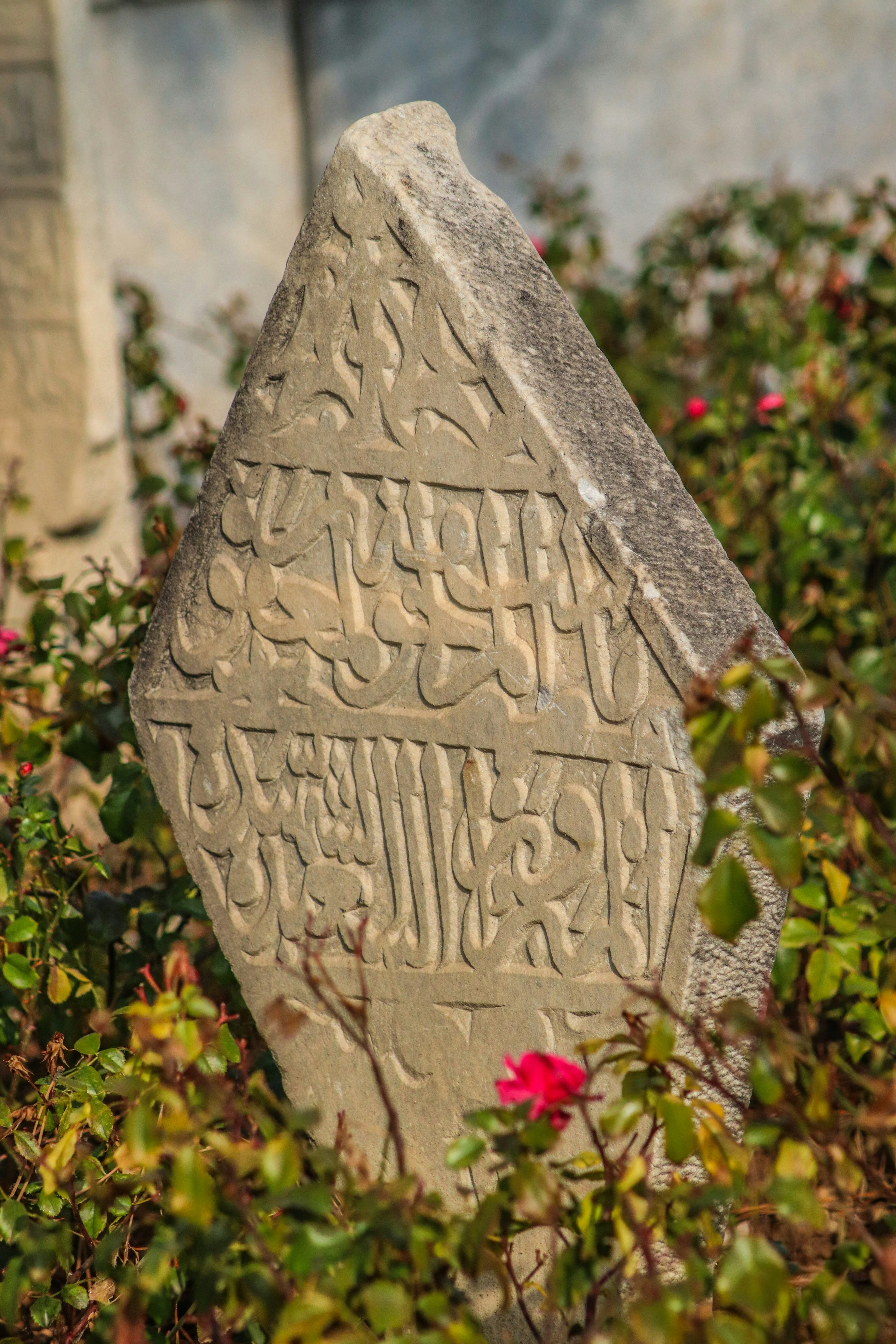An old stone tombstone with arabic inscriptions.