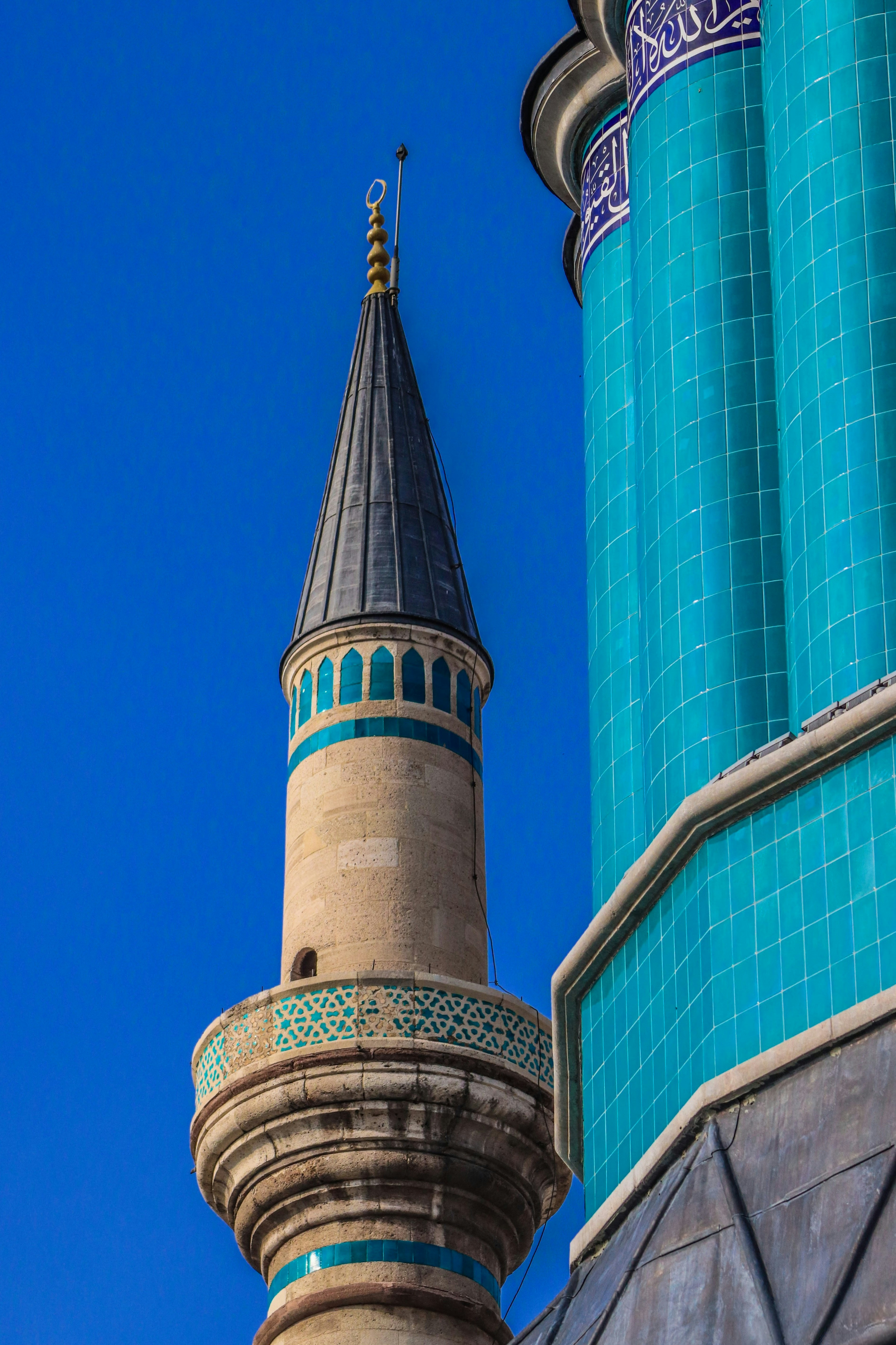 Minaret of a mosque against a clear blue sky