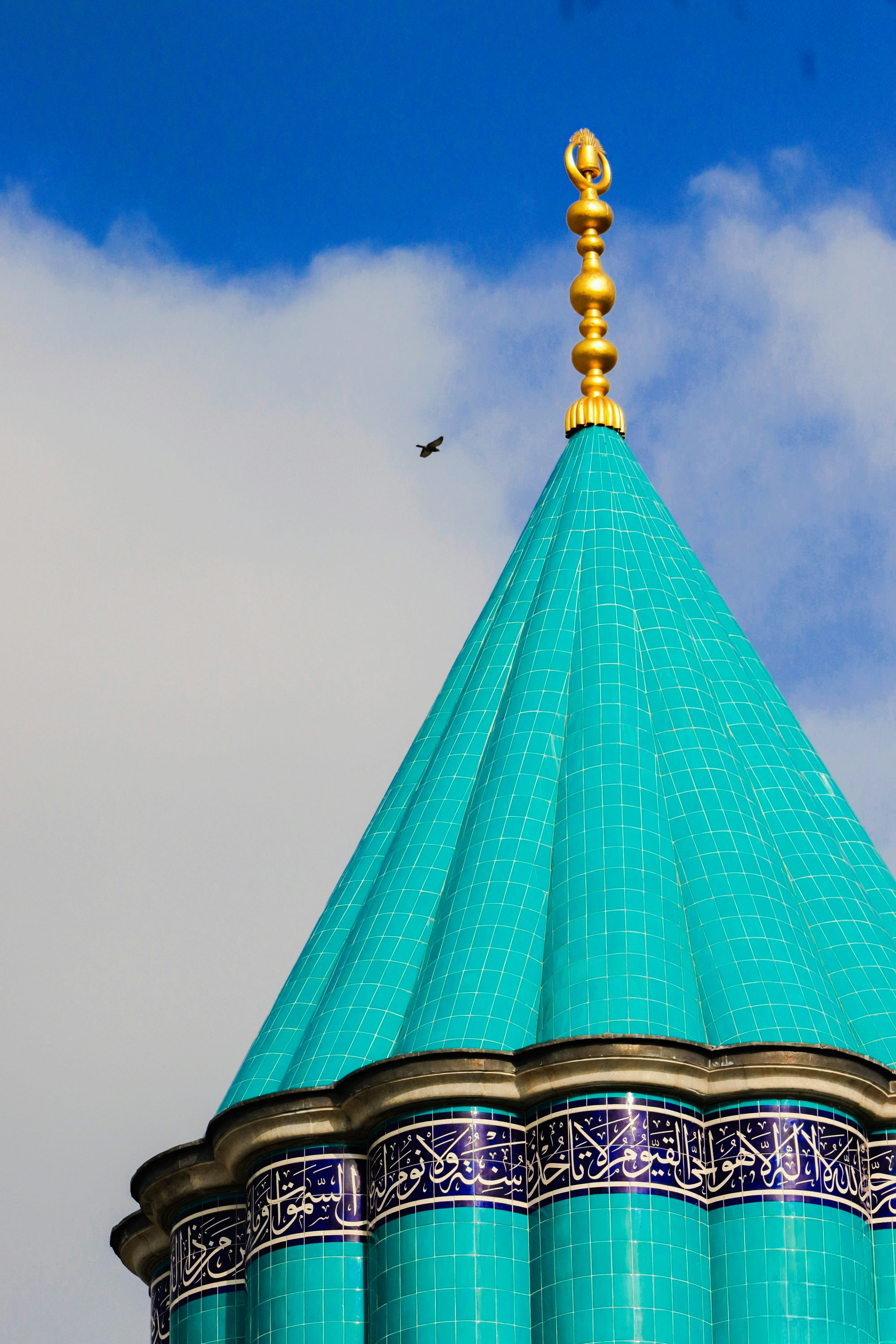 Turquoise domed building with ornate blue and gold details.