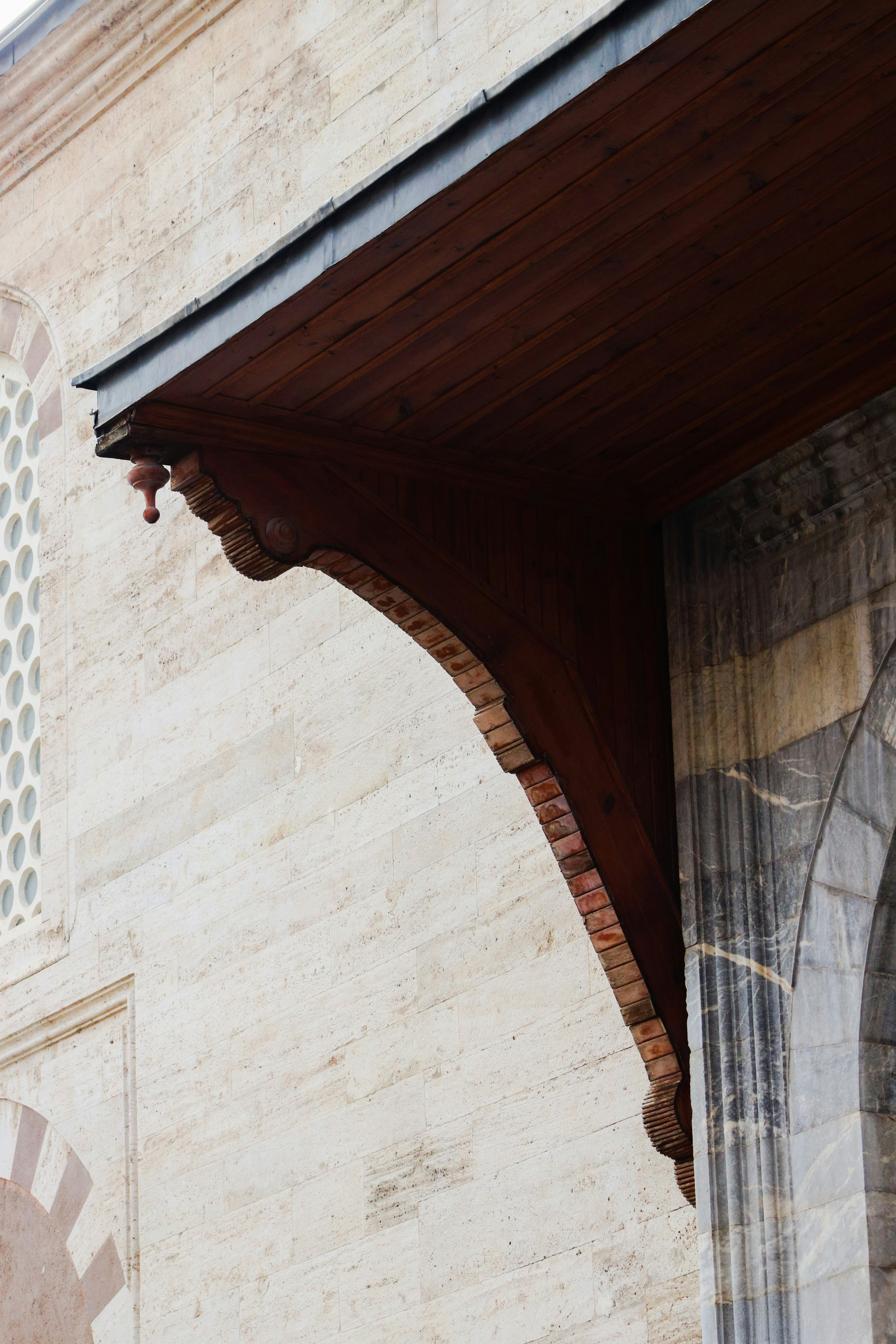 Detail of ornate wooden eaves on stone building