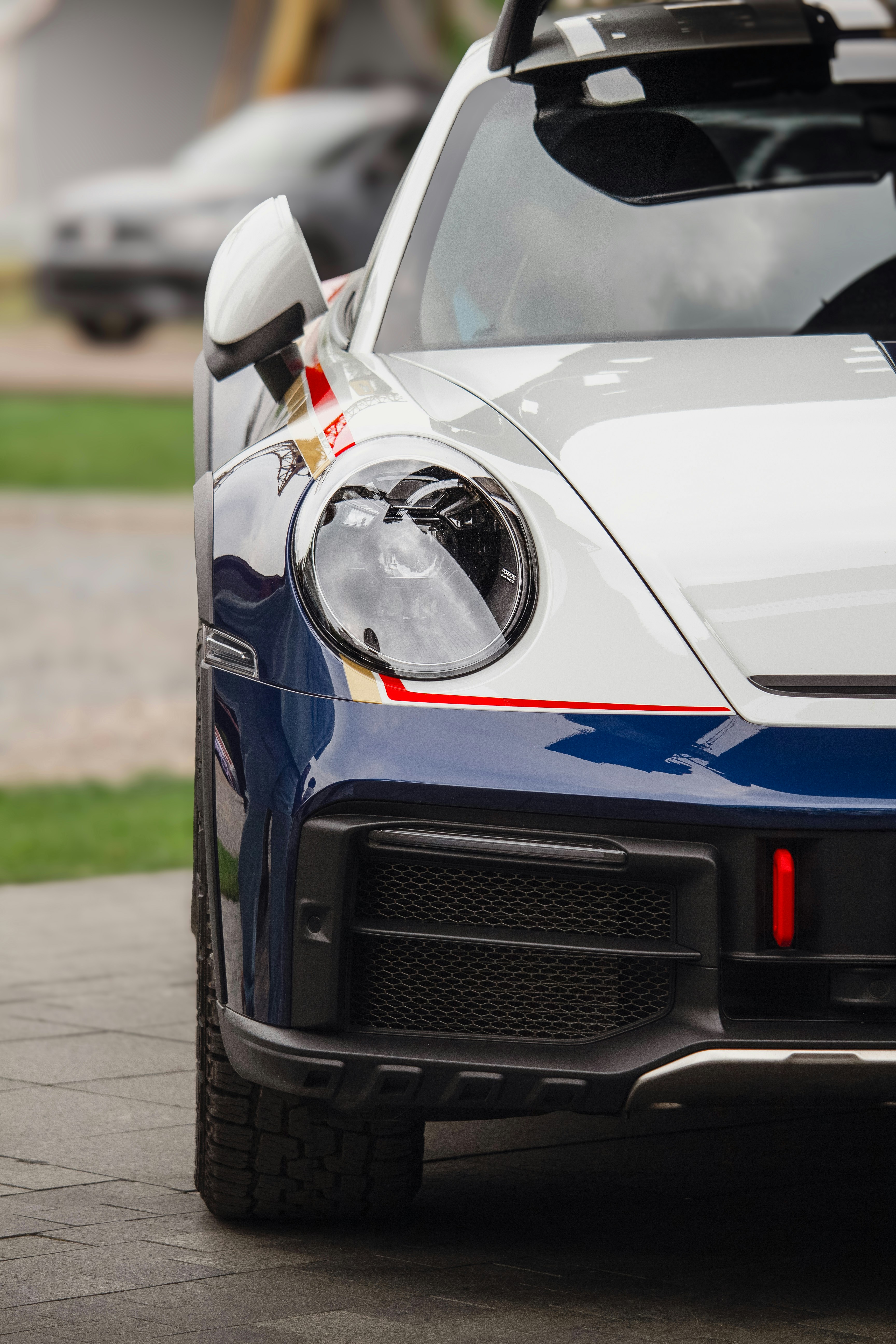 White and blue sports car parked outdoors