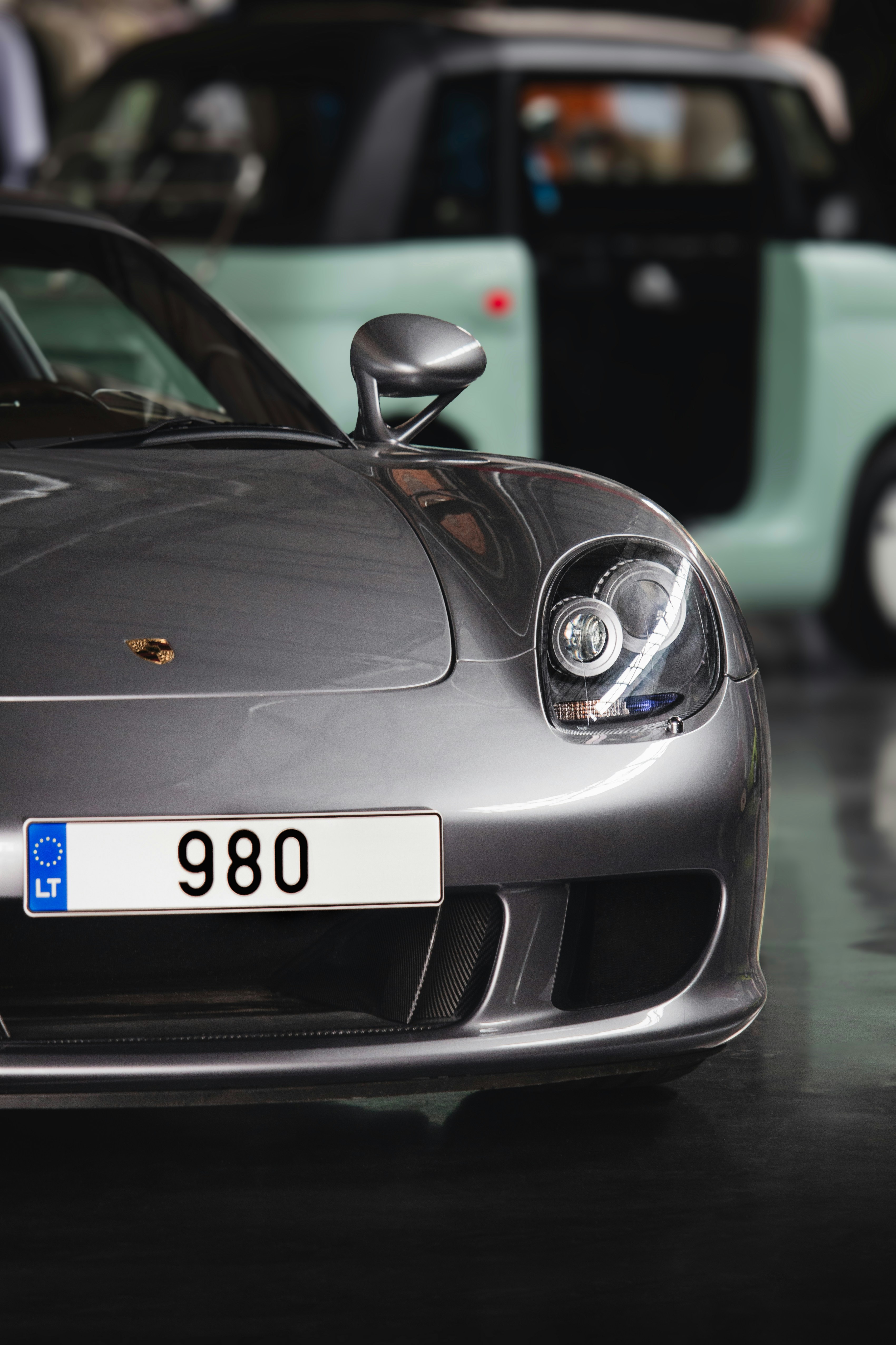 Silver sports car with license plate 980.