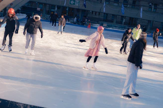 People ice skating on an outdoor rink.