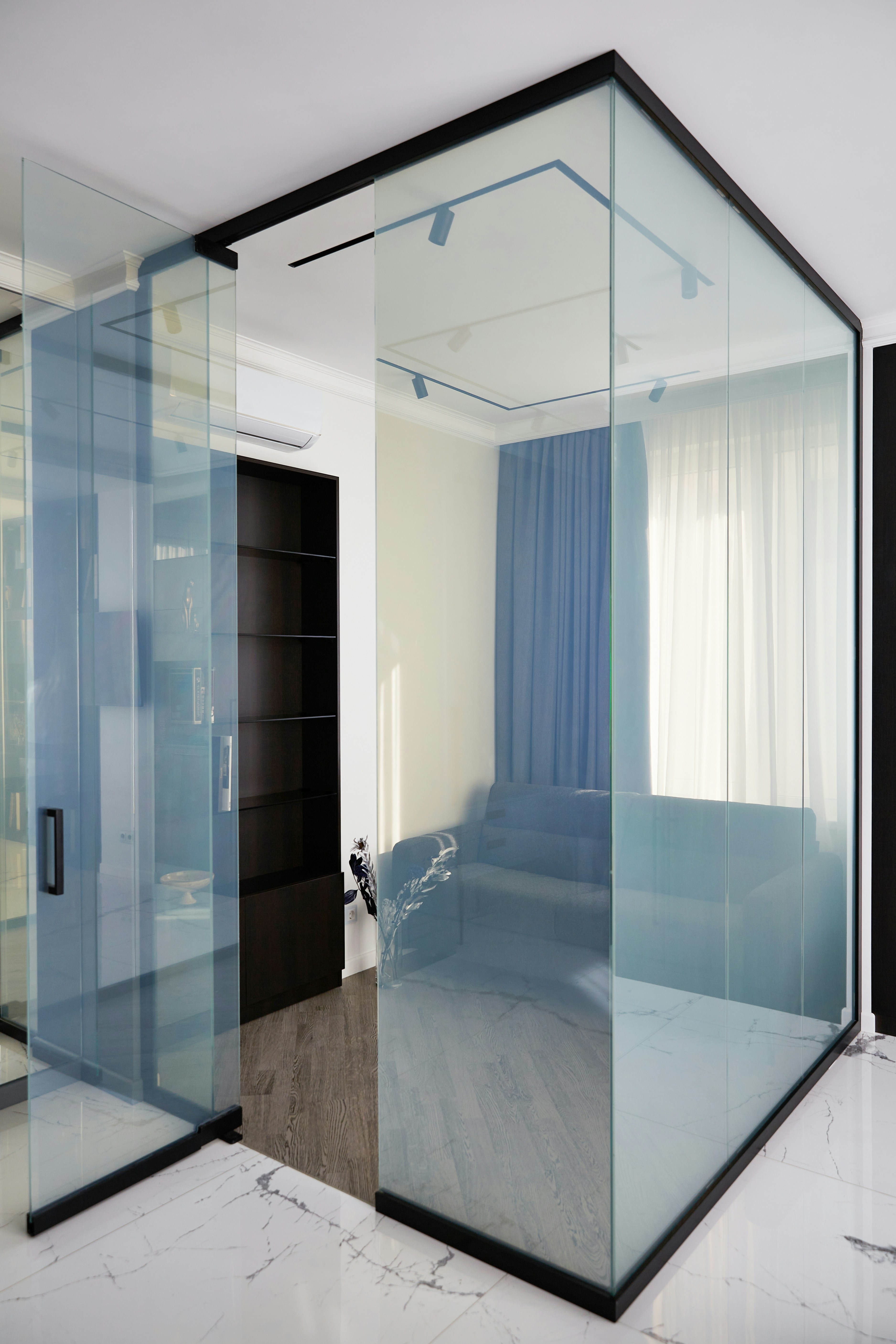 Modern interior with glass walls and blue curtains