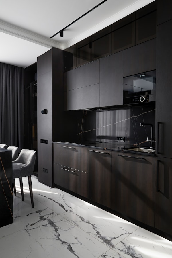 Modern dark kitchen with marble floor