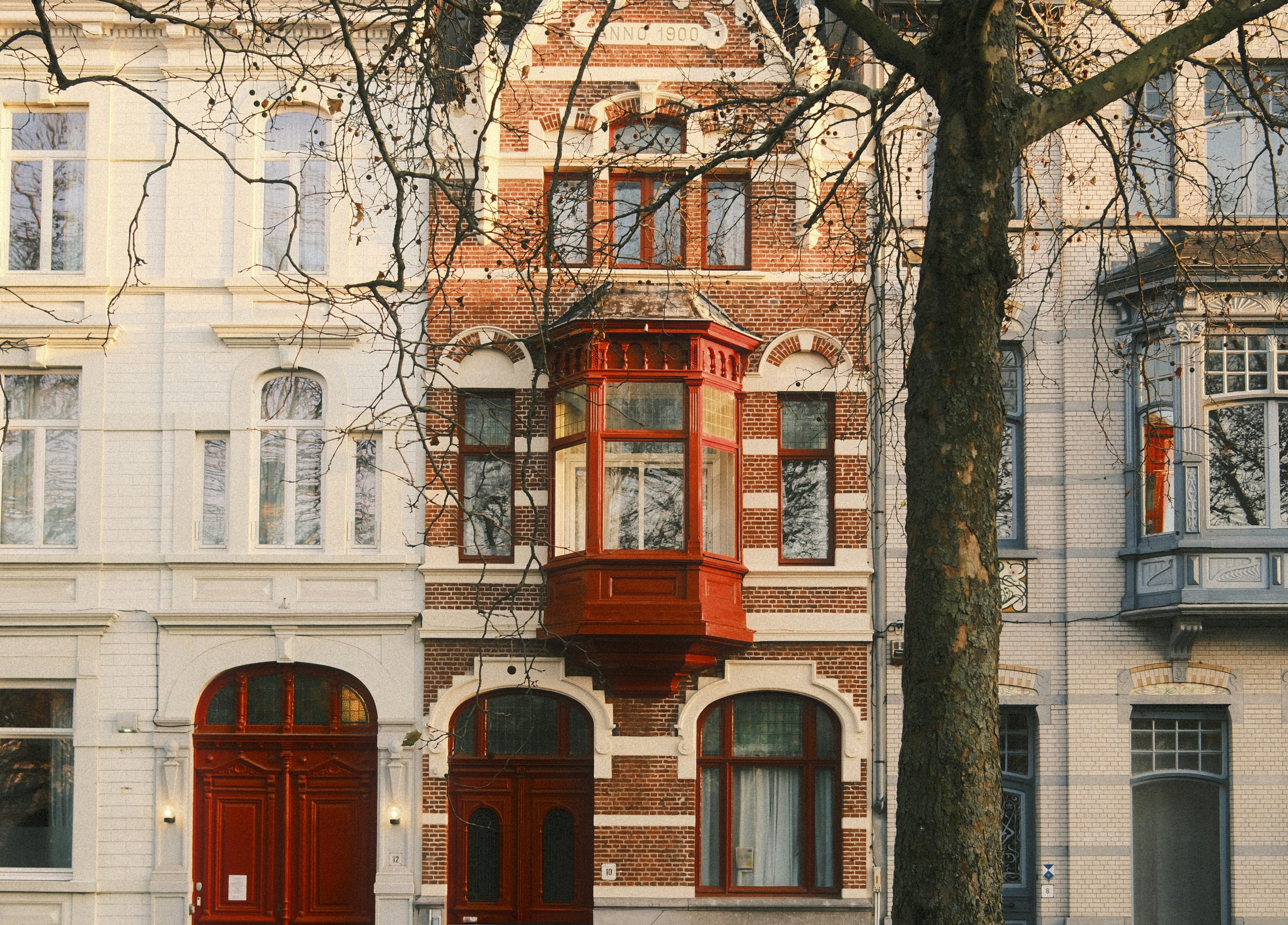 Ornate brick building with red doors and window