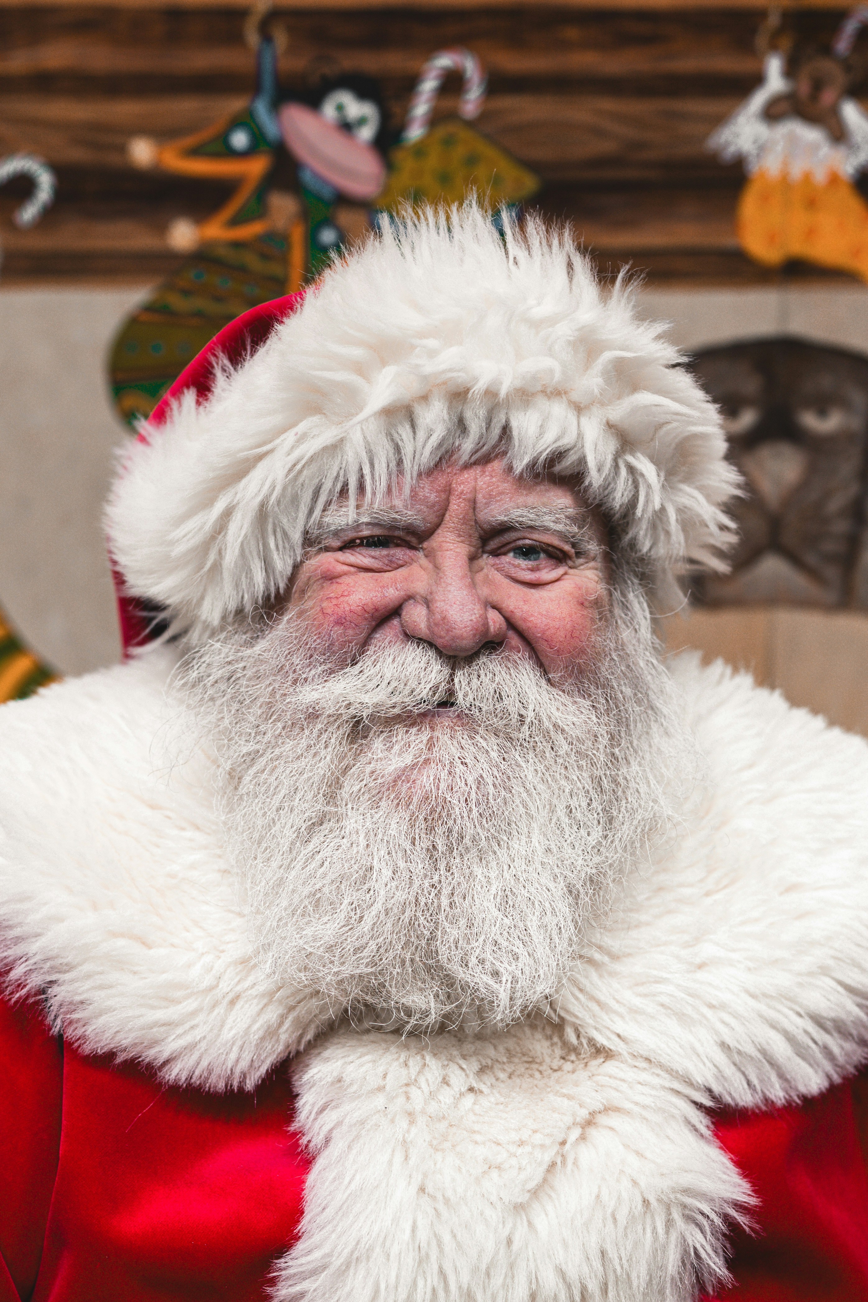 Santa claus winks with a warm smile.