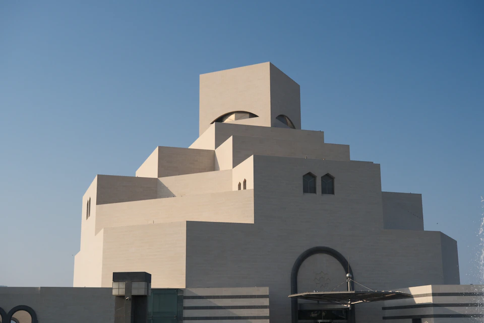 Large modern building with unique architectural design featuring multiple levels and a distinctive dome