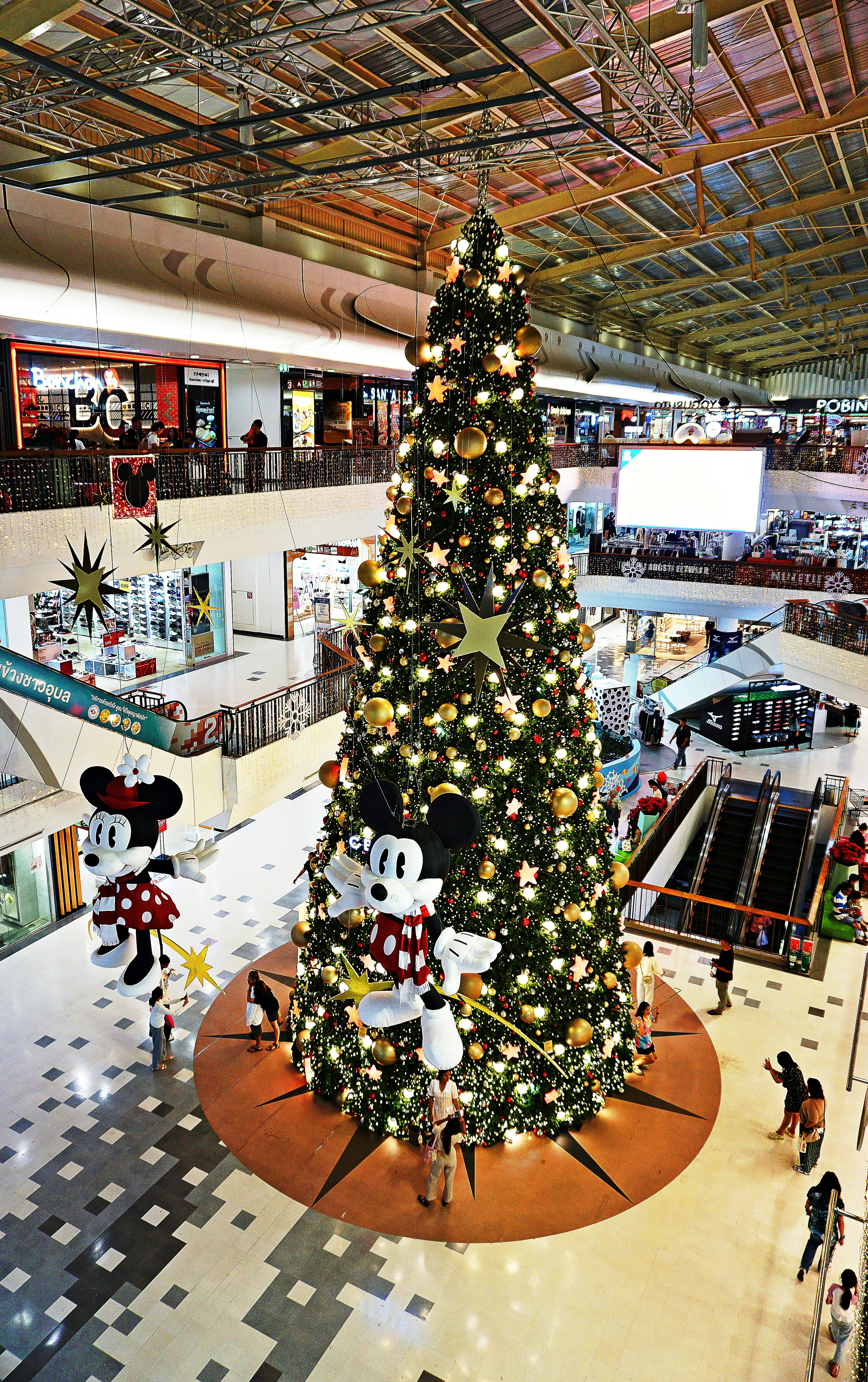 Decorated christmas tree with mickey and minnie balloons.