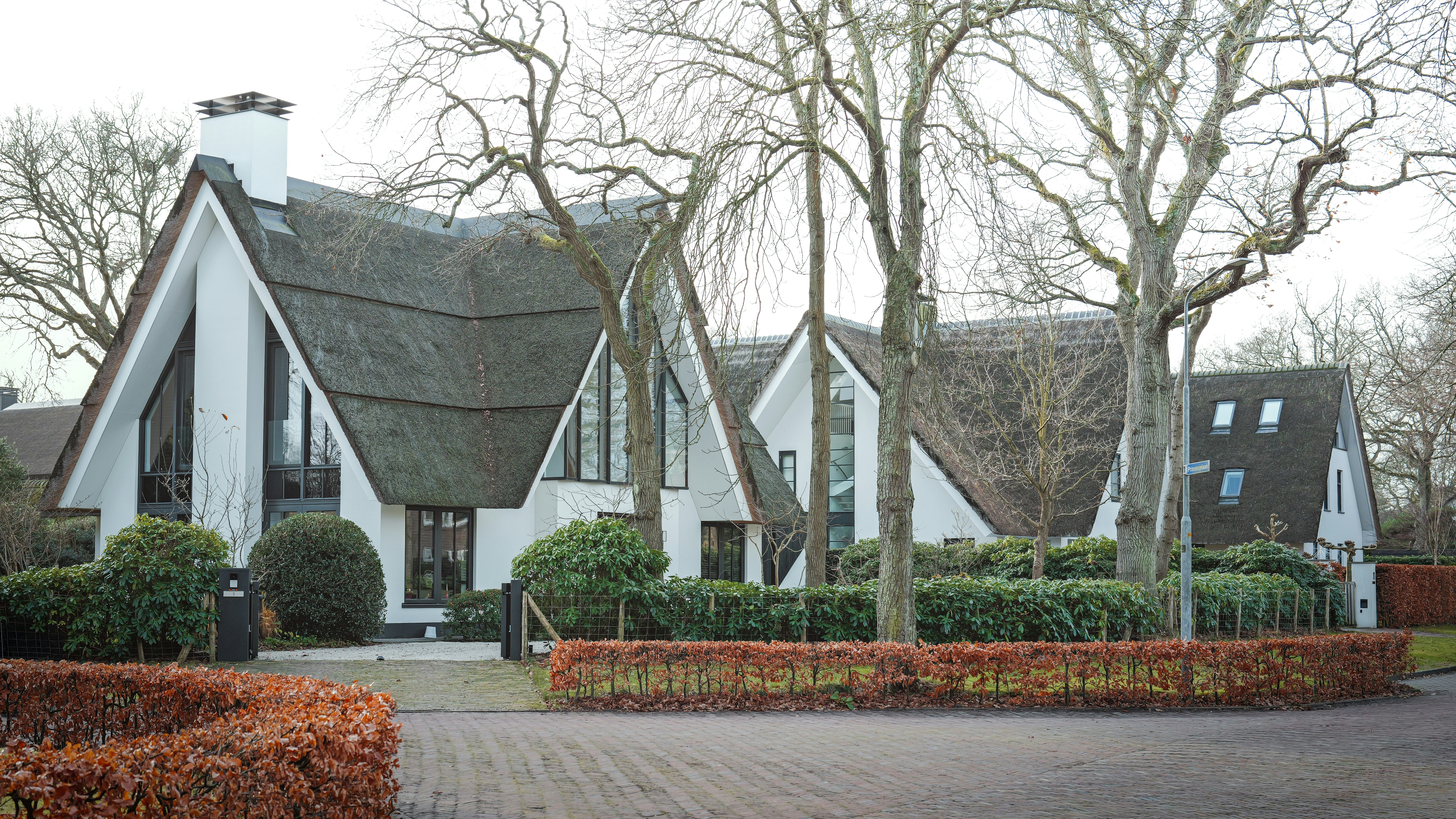 A large white house with a thatched roof.