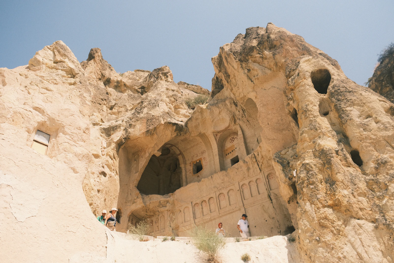 Ancient cave dwellings carved into a rocky hillside, evoking the caves and strongholds where David hid from Saul