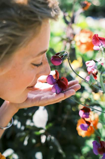 Woman smelling a pink and purple flower
