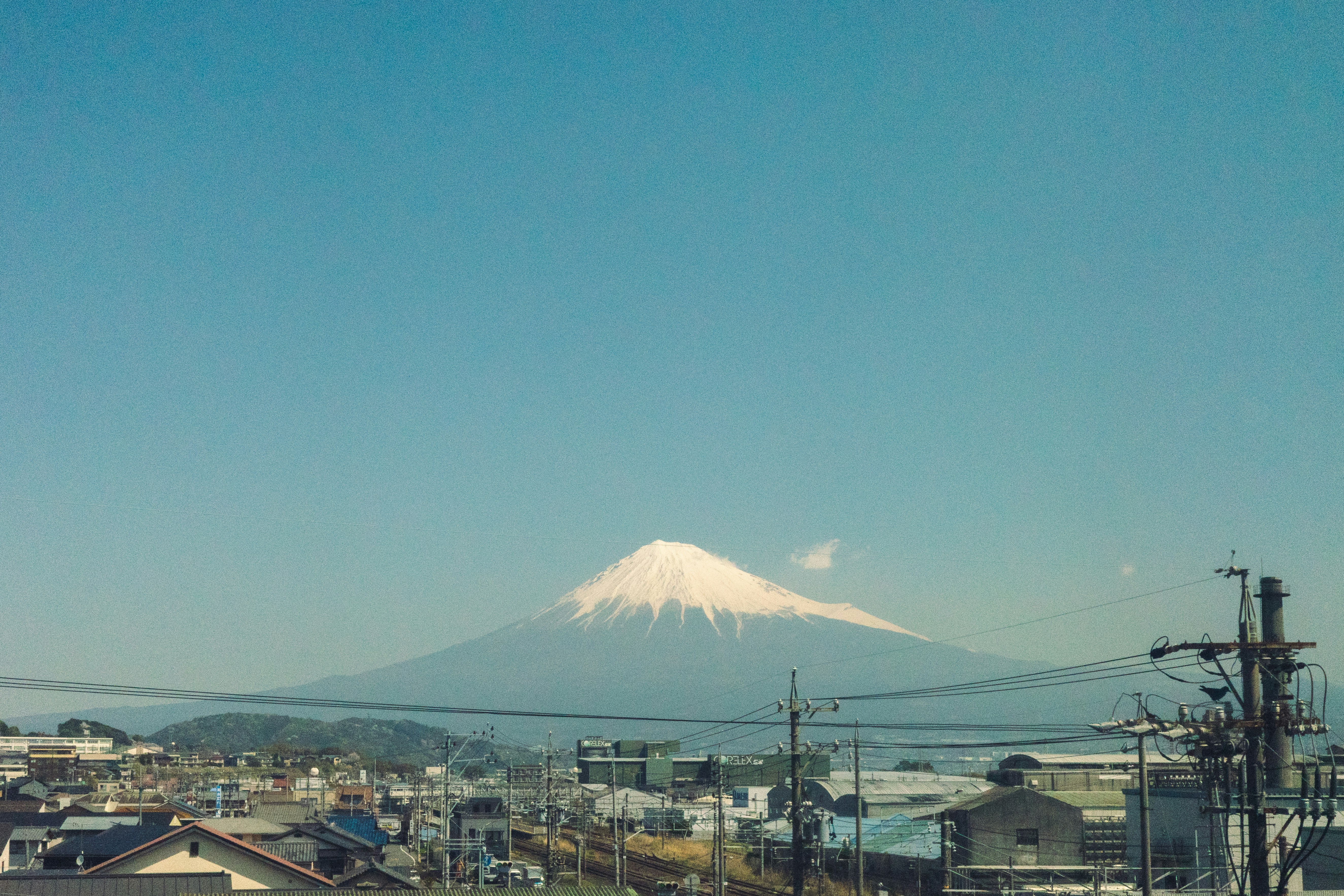 Snow-capped mount fuji under a clear blue sky.