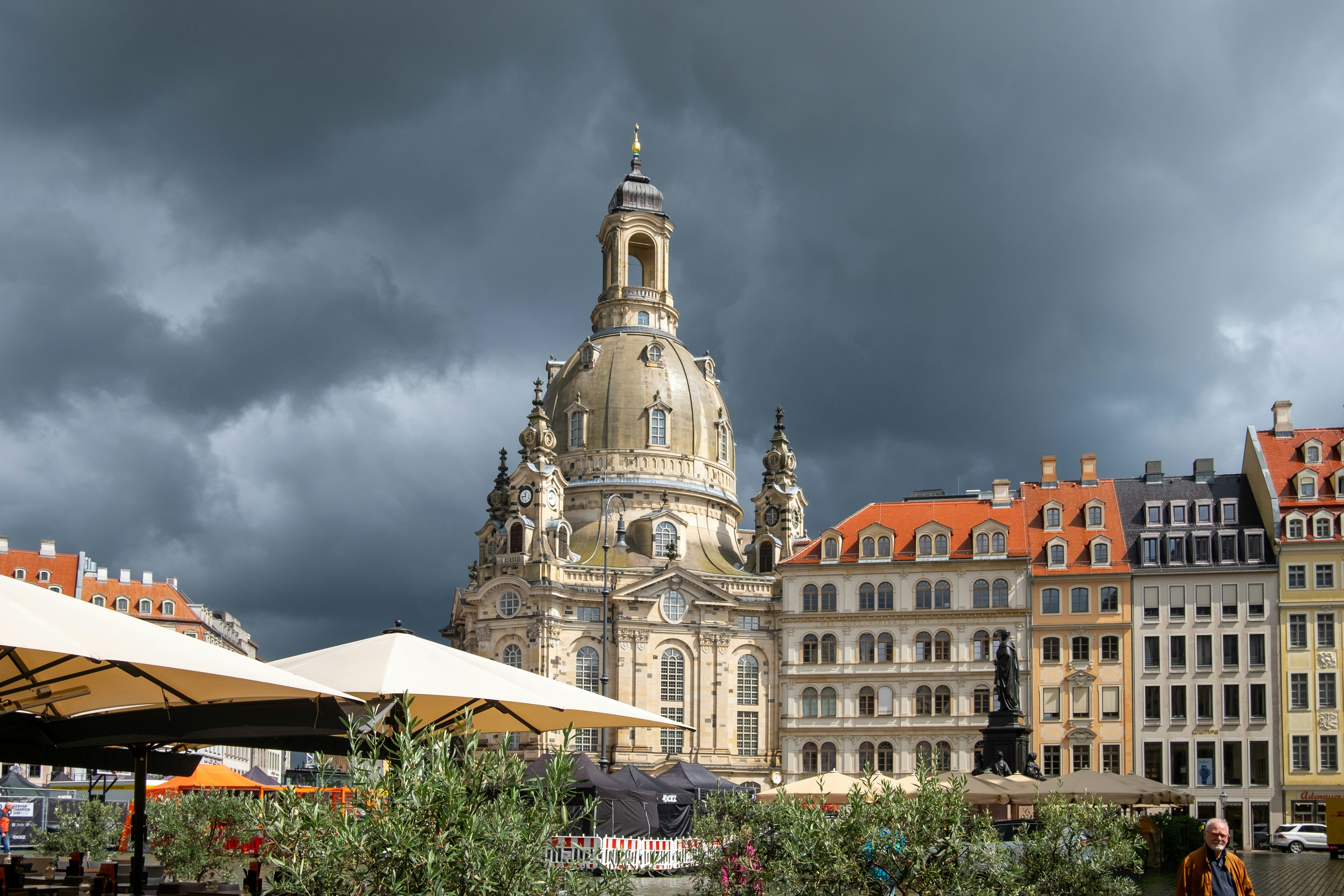 Historic church and buildings under stormy sky