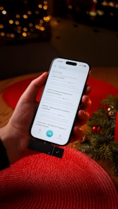 Hand holding smartphone with search results displayed