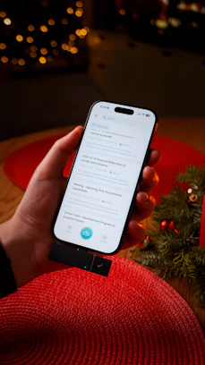Hand holding smartphone with search results displayed