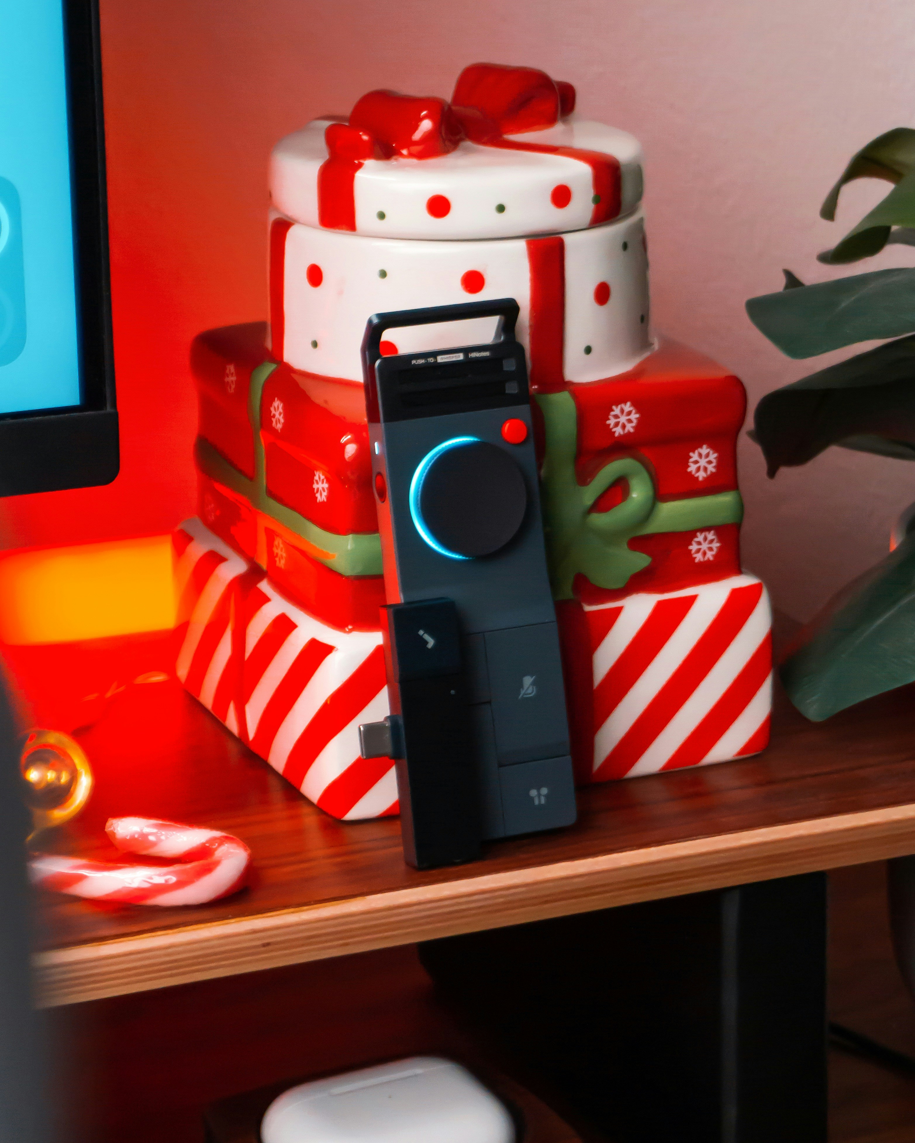 Stack of christmas gift boxes with audio device