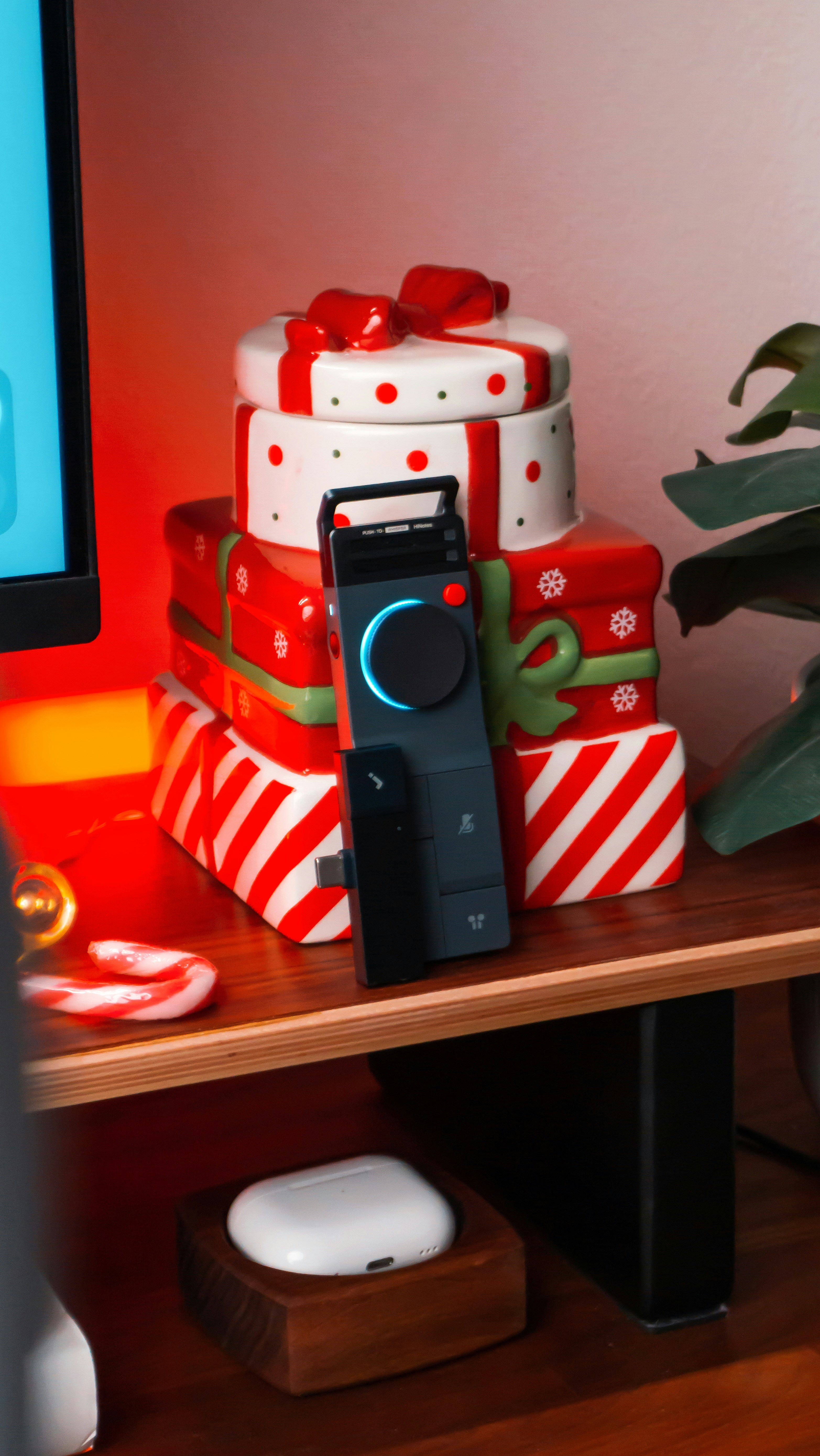 Stack of festive gift boxes with electronic devices.