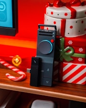 Electronic device with christmas gifts and candy cane.