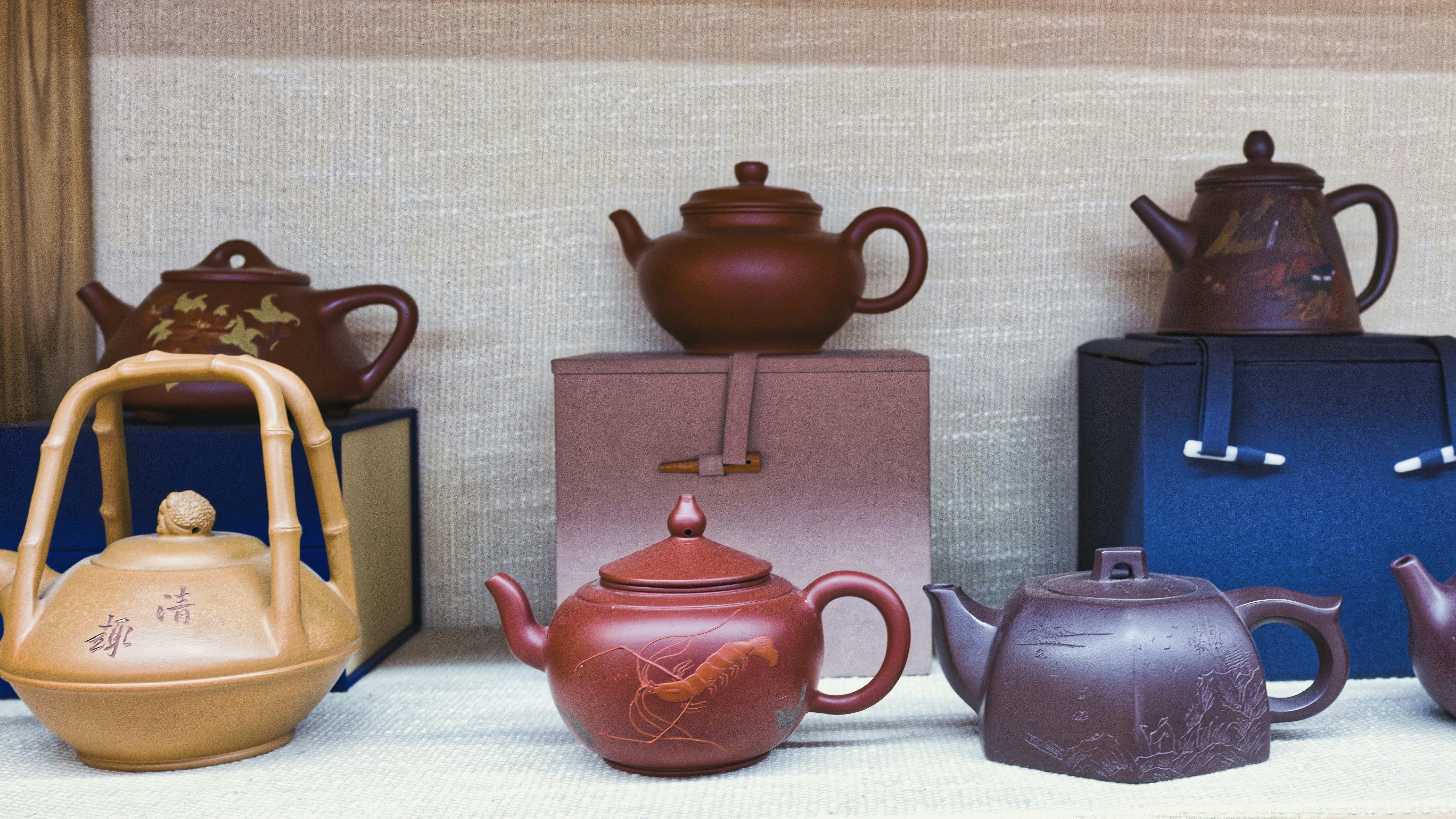 Collection of decorative ceramic teapots on display