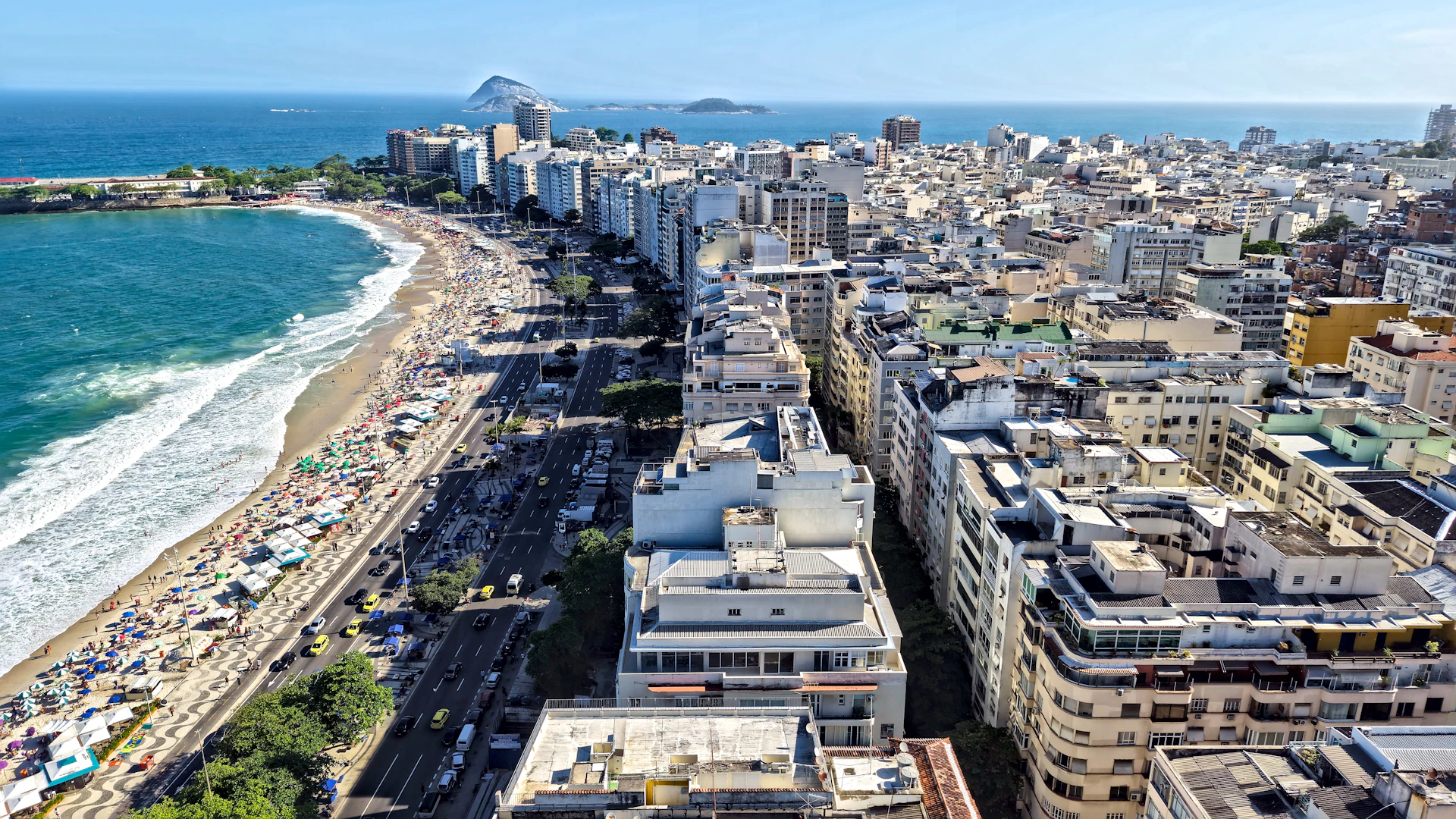 Aerial view of a bustling city beach and coastline.