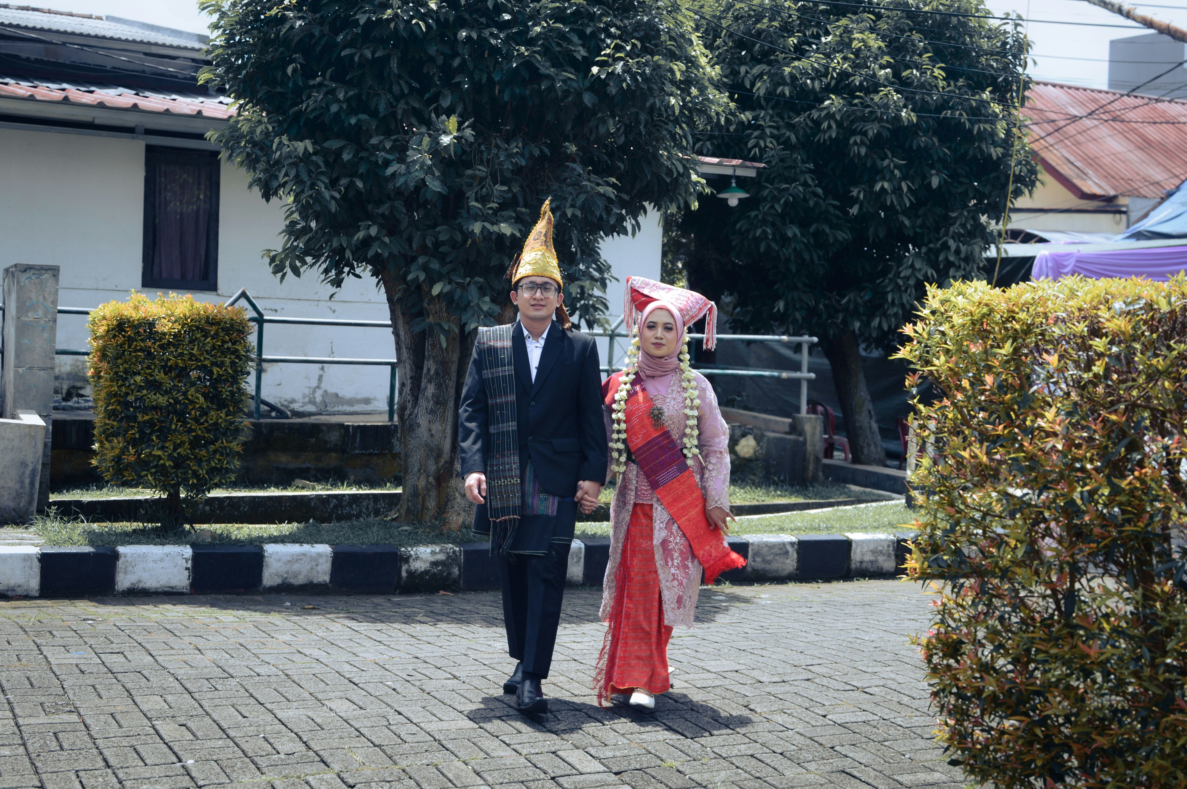Couple in traditional attire walking outdoors