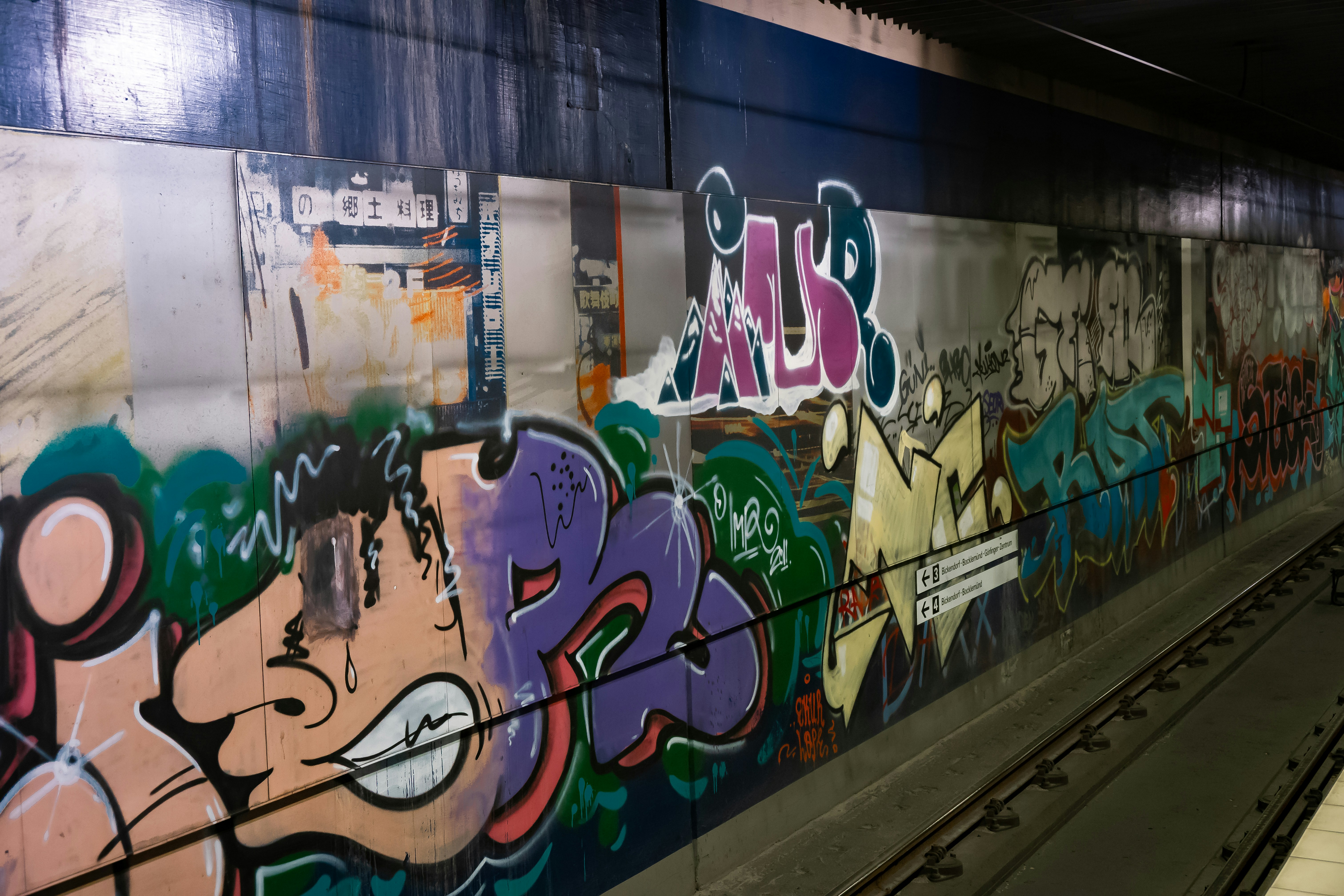 Graffiti art covers a subway station wall.