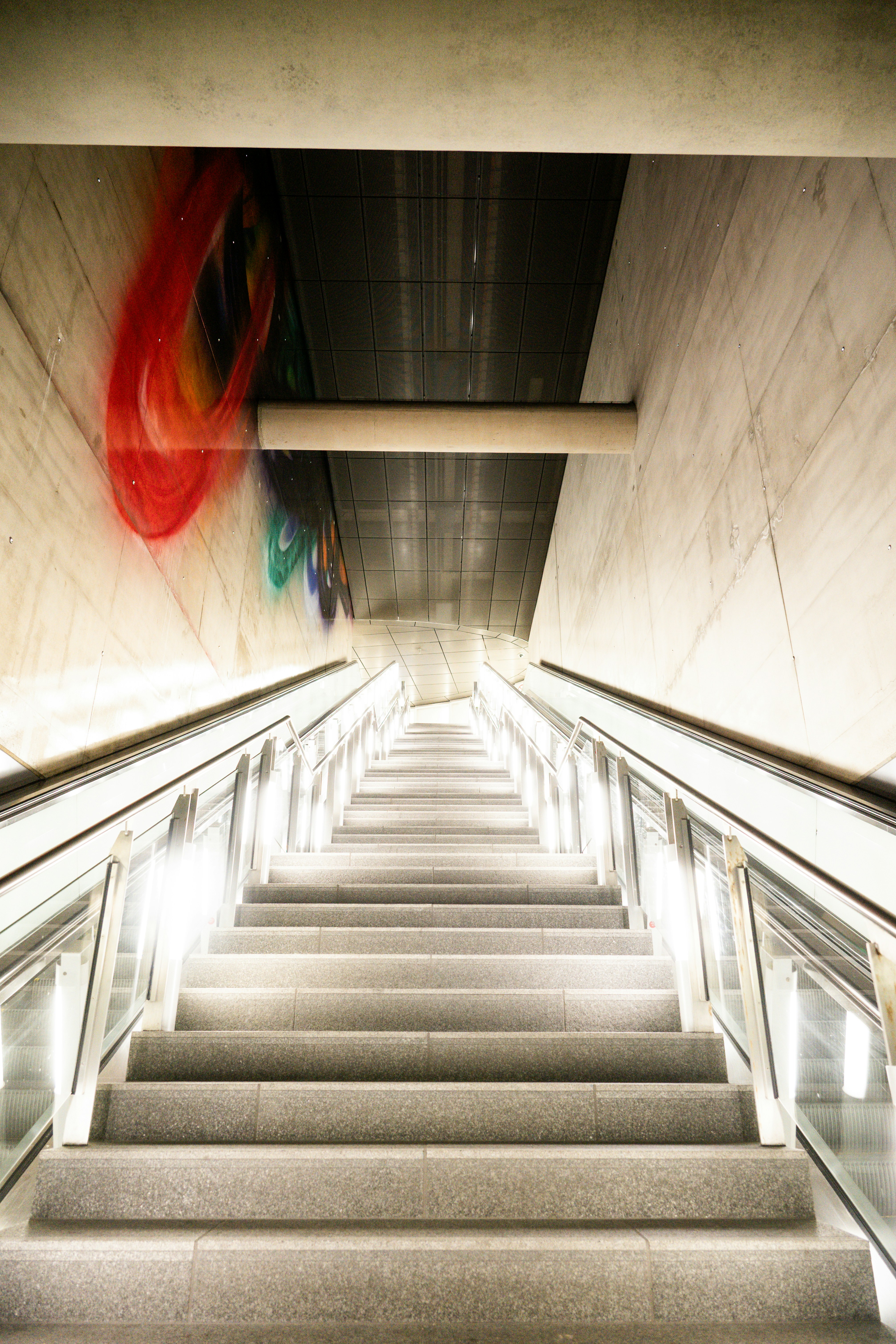 Escalator leading up in a modern subway station.