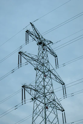 A tall metal electricity pylon against a cloudy sky