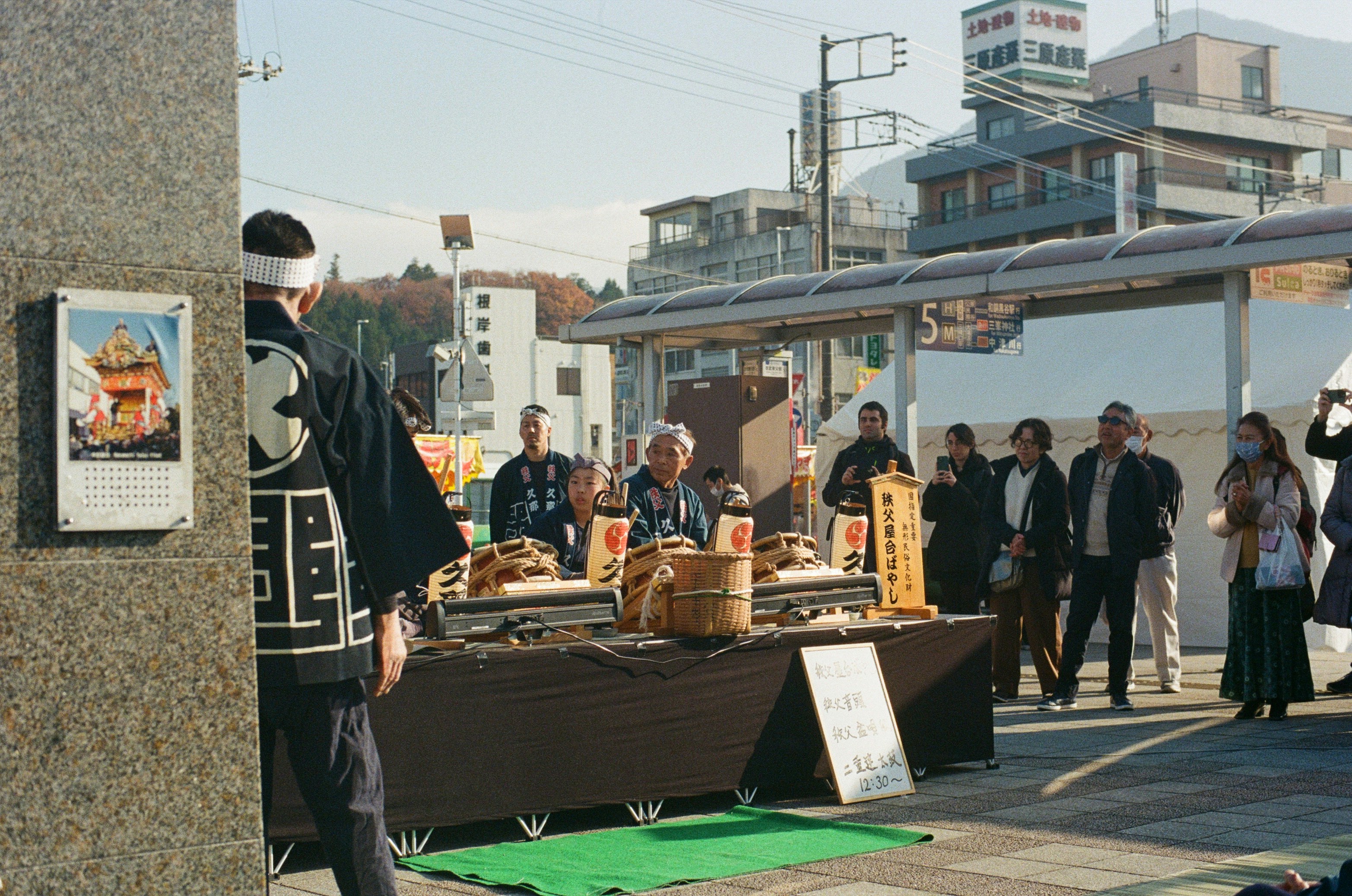 Person performing purification ritual at a temizuya with ladle