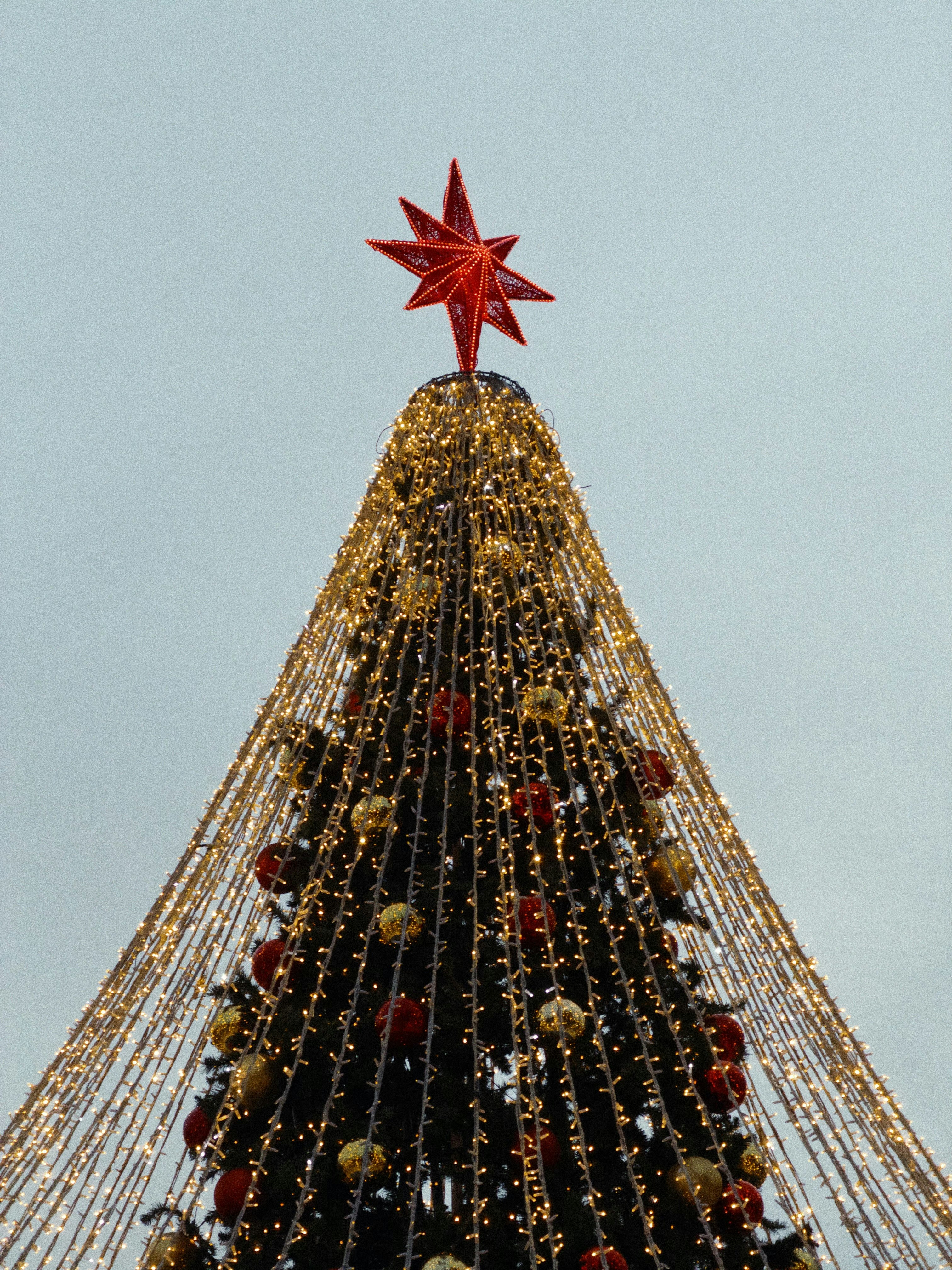 A decorated christmas tree with a red star.