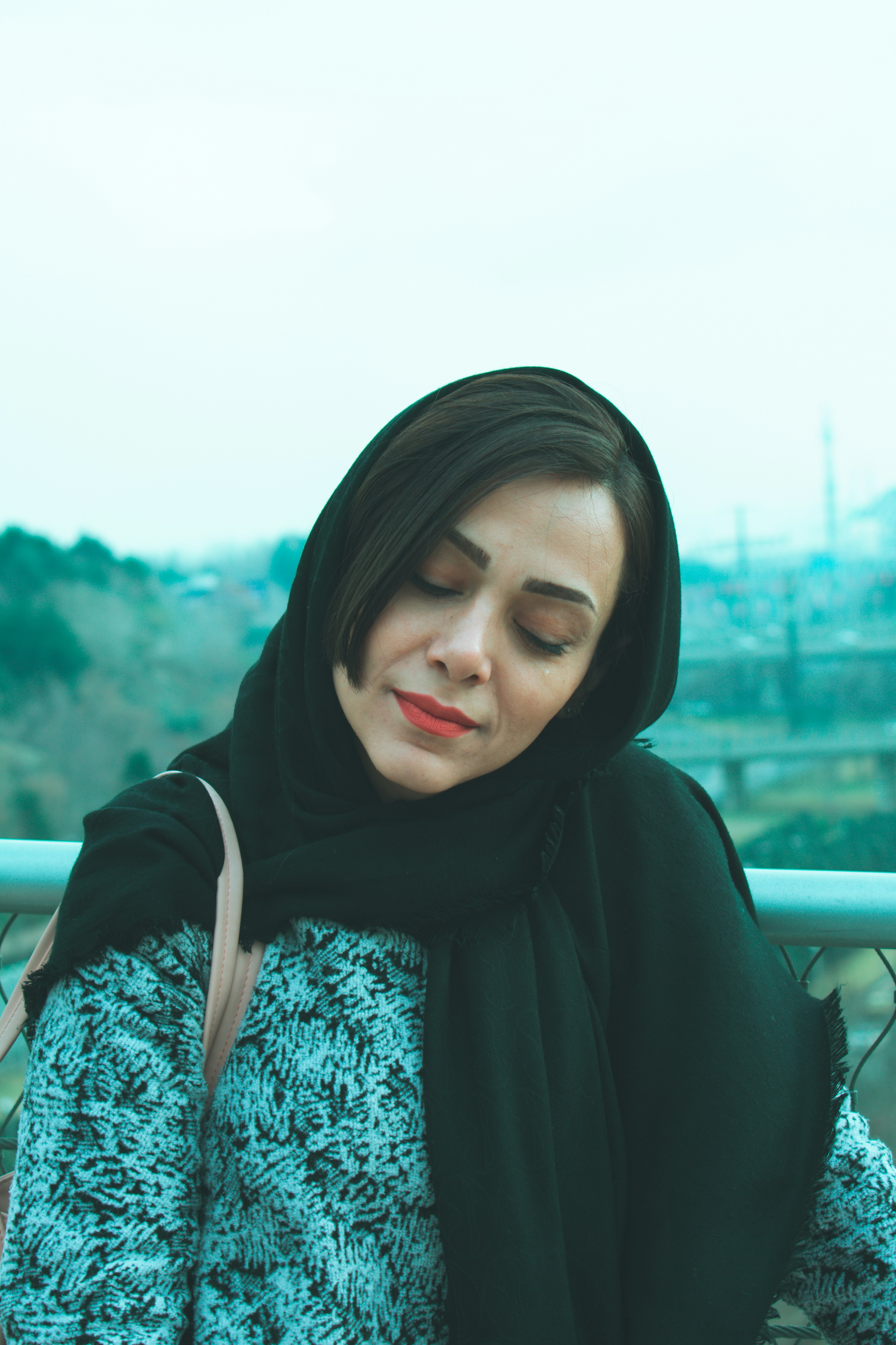 Femme portant un hijab noir et un pull à motifs