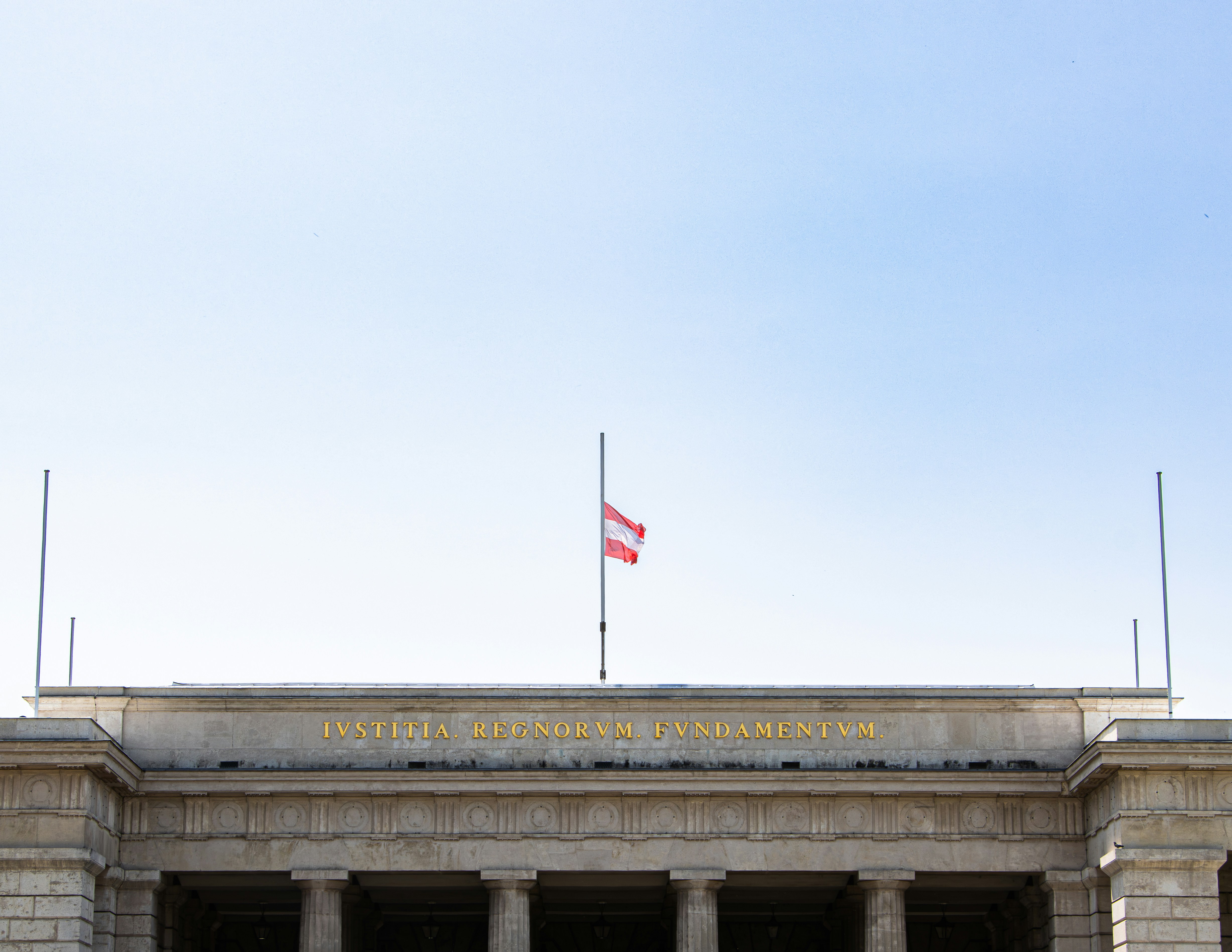 Austrian flag at half mast on building