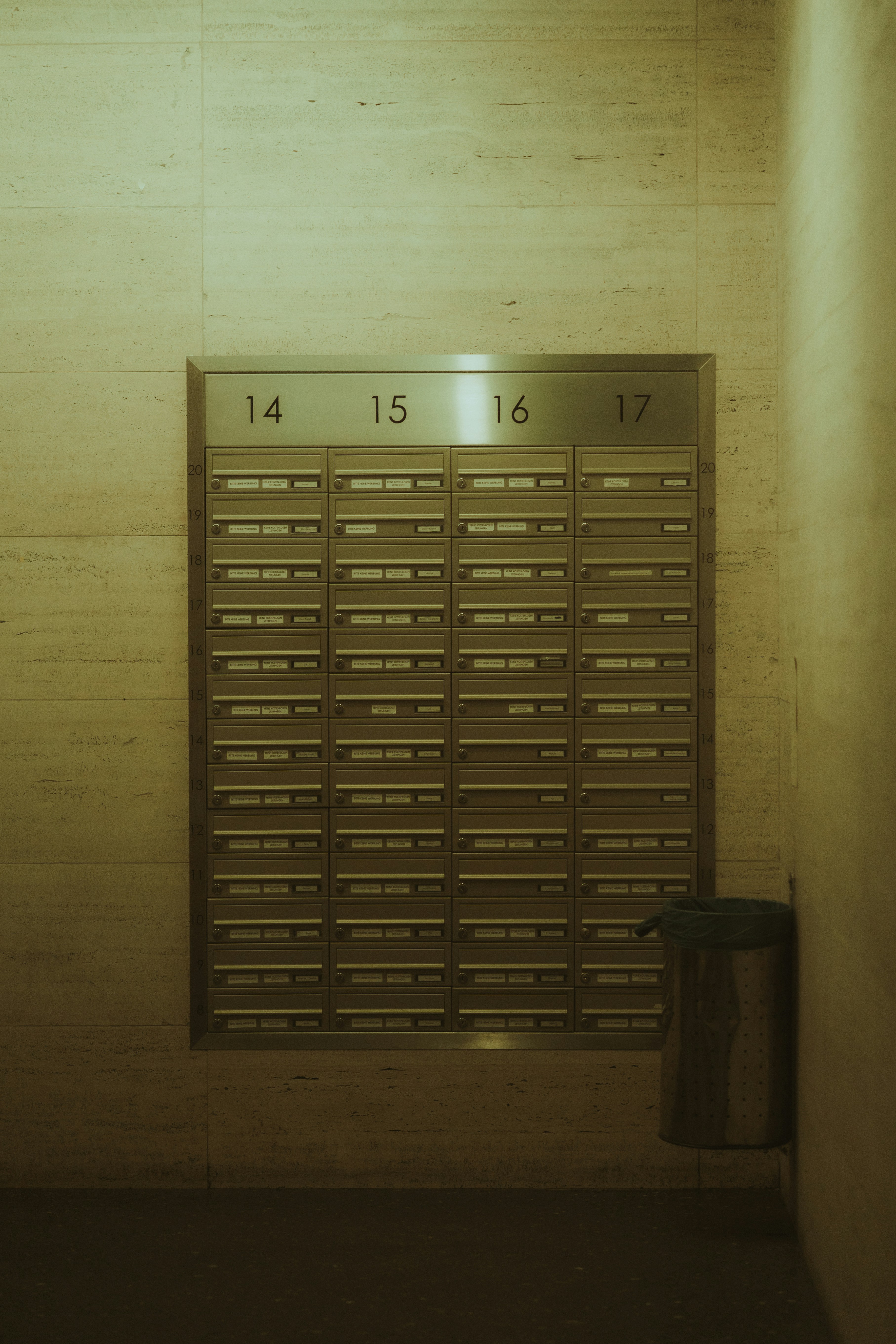 Mailboxes numbered 14 through 17 in a hallway.
