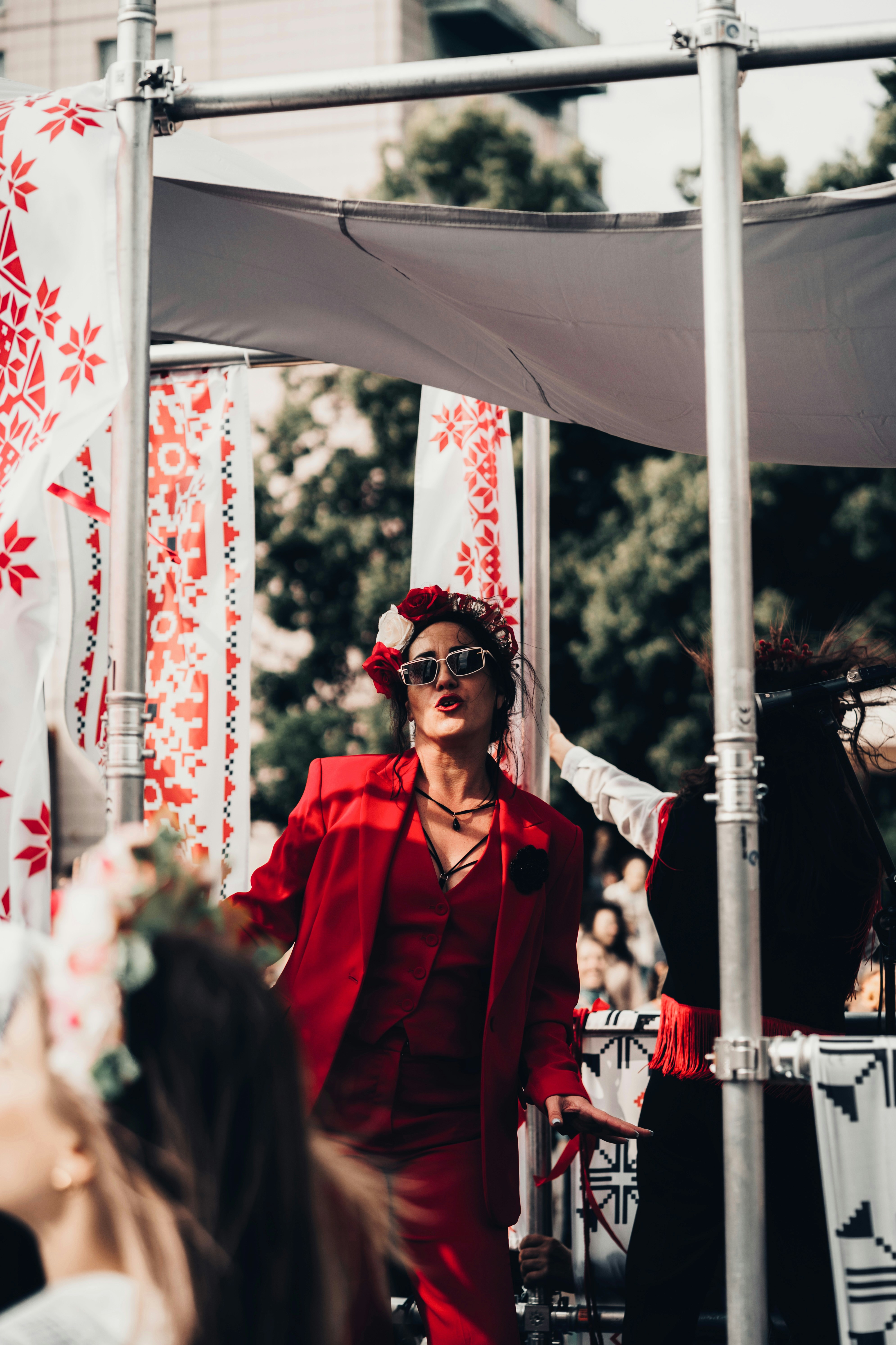 Woman in red suit dancing at outdoor event